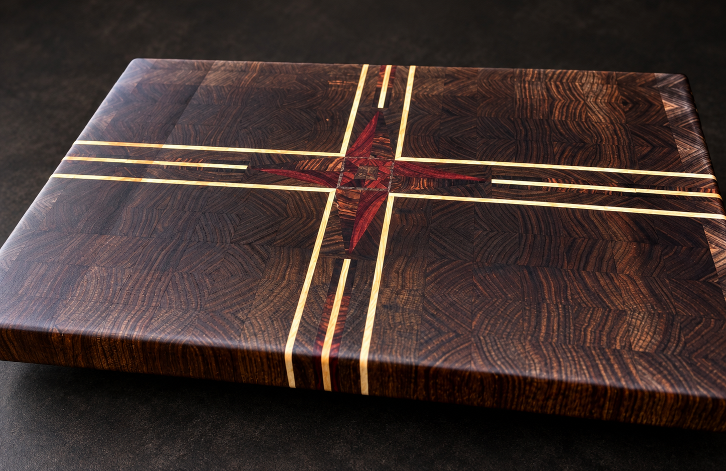 Handcrafted end-grain cutting board featuring a geometric compass-inspired inlay design.