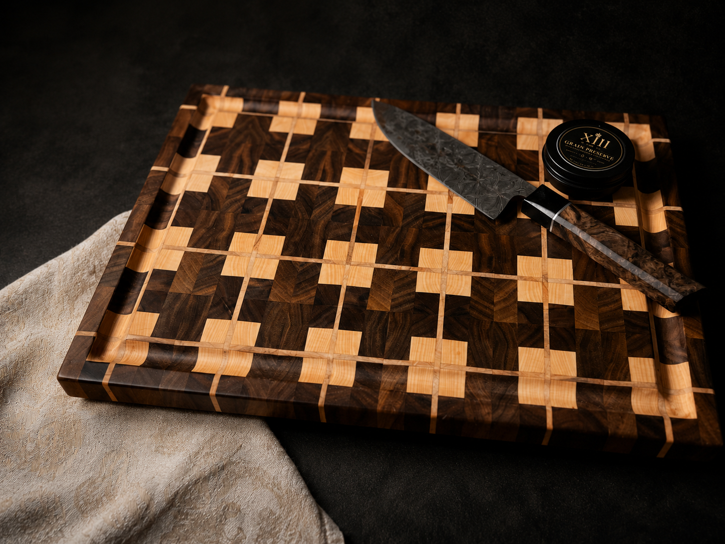 Handcrafted end-grain cutting board photographed with a chef’s knife and XIII wood care balm.