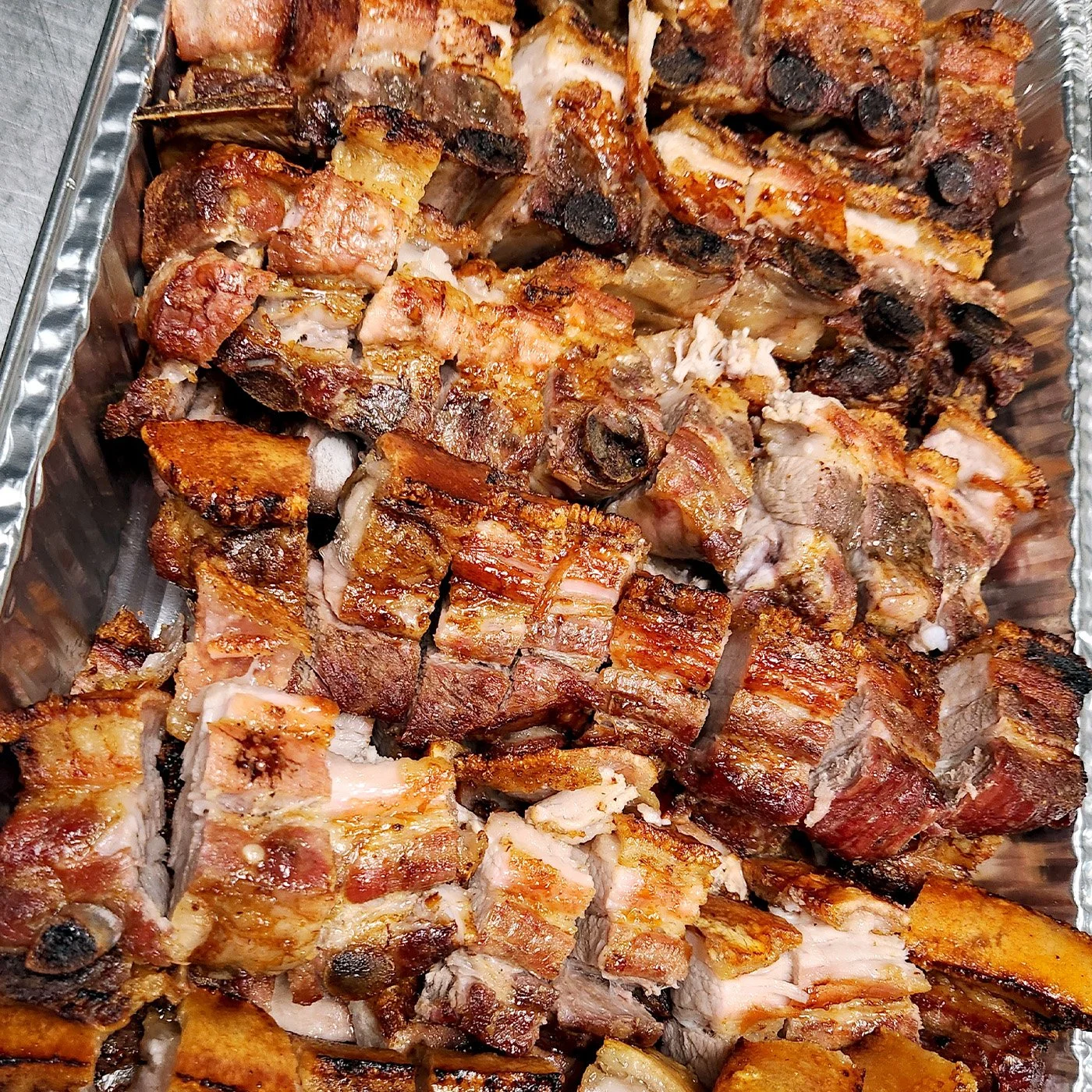 A tray of our roasted pork belly that has been chopped for a catering order