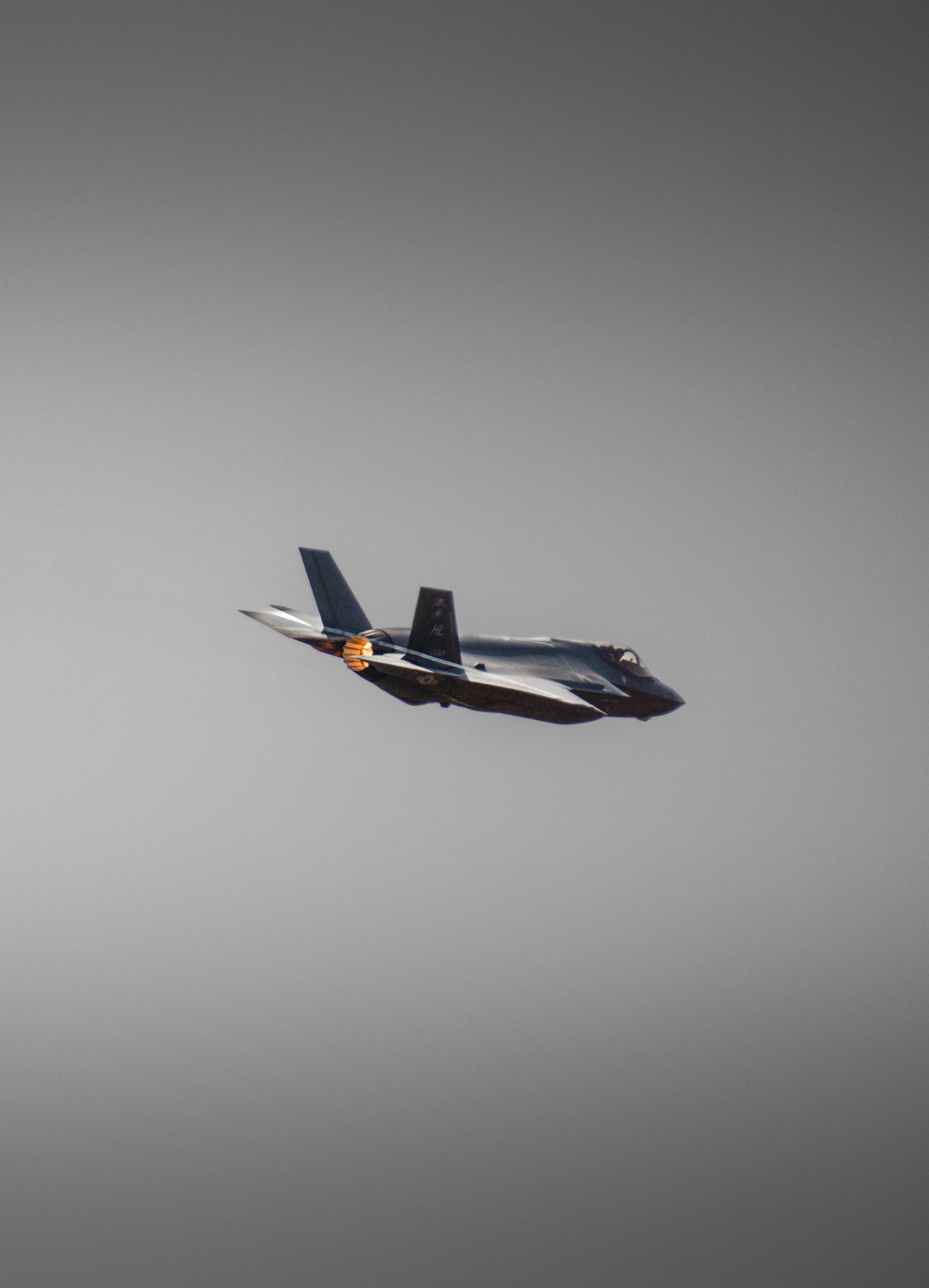 A fighter jet aircraft flying in the sky during daytime.