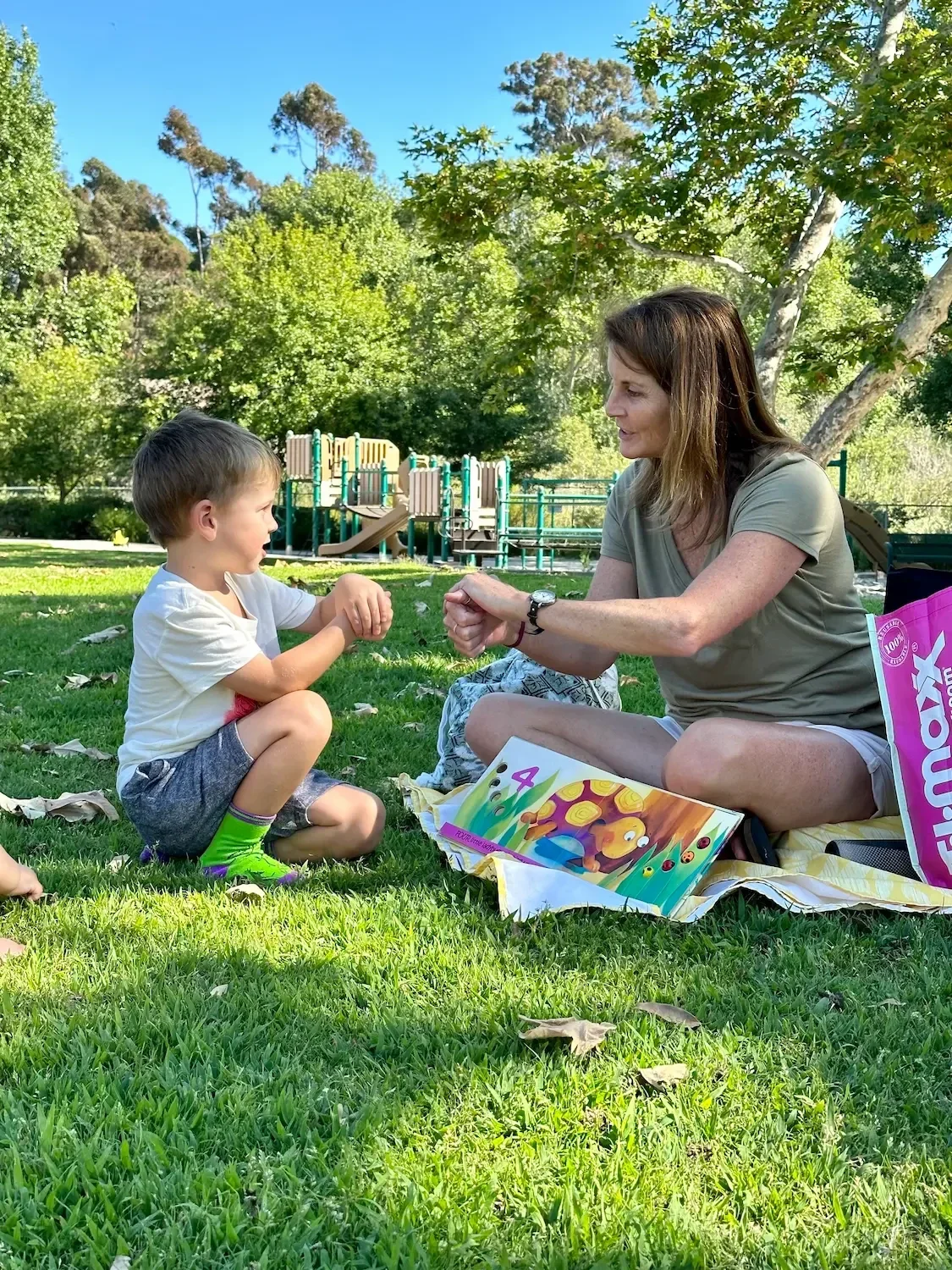 laura-greer-pat-a-cake-with-child-encinitas-park.webp