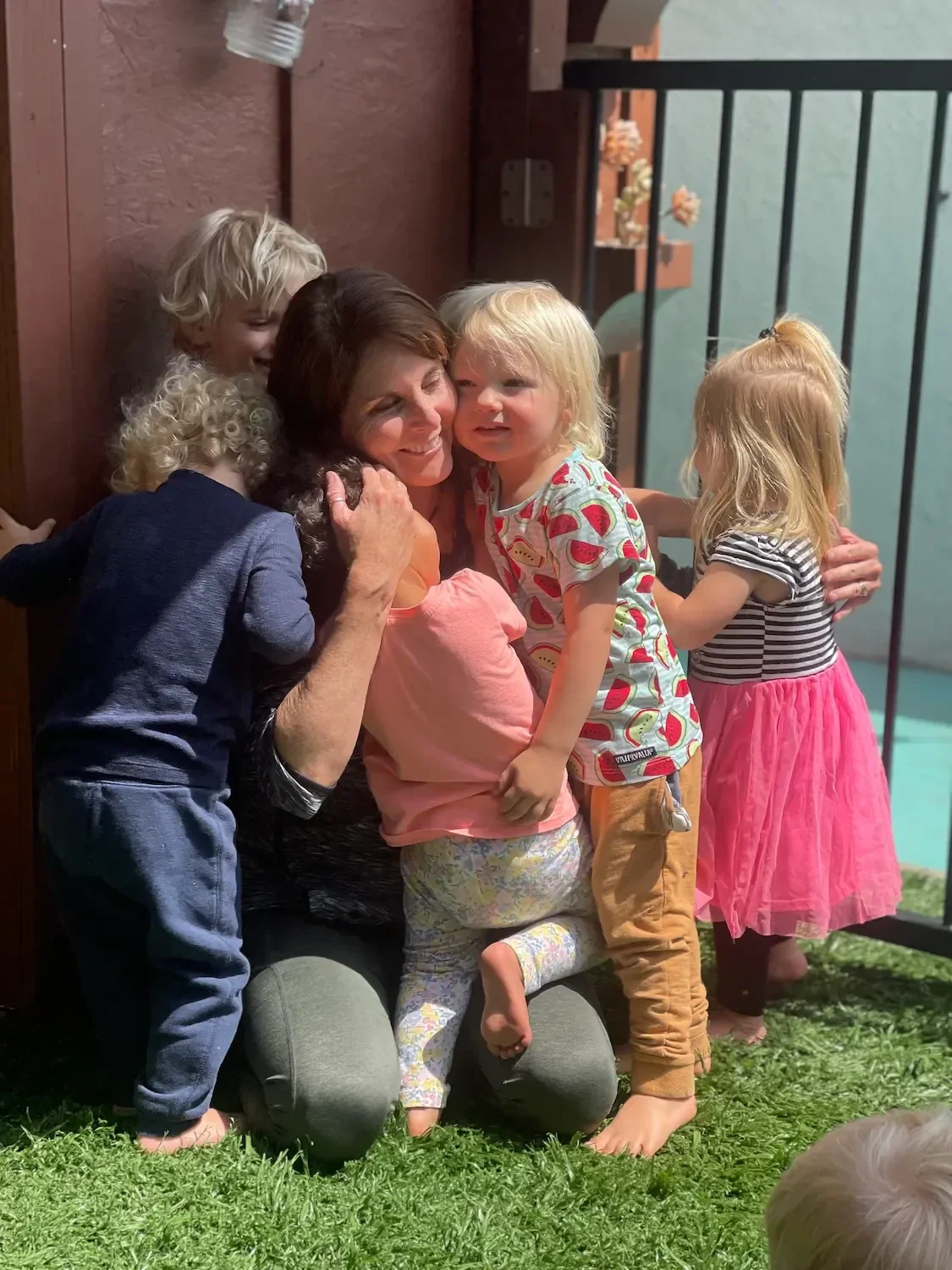 laura-greer-hugging-preschool-kids-encinitas.webp