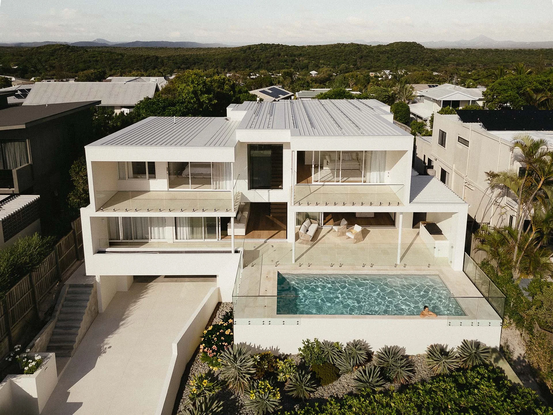 Aerial view of Horizon House at Sunrise Beach, showing glass balustrades across the balconies and swimming pool terrace.