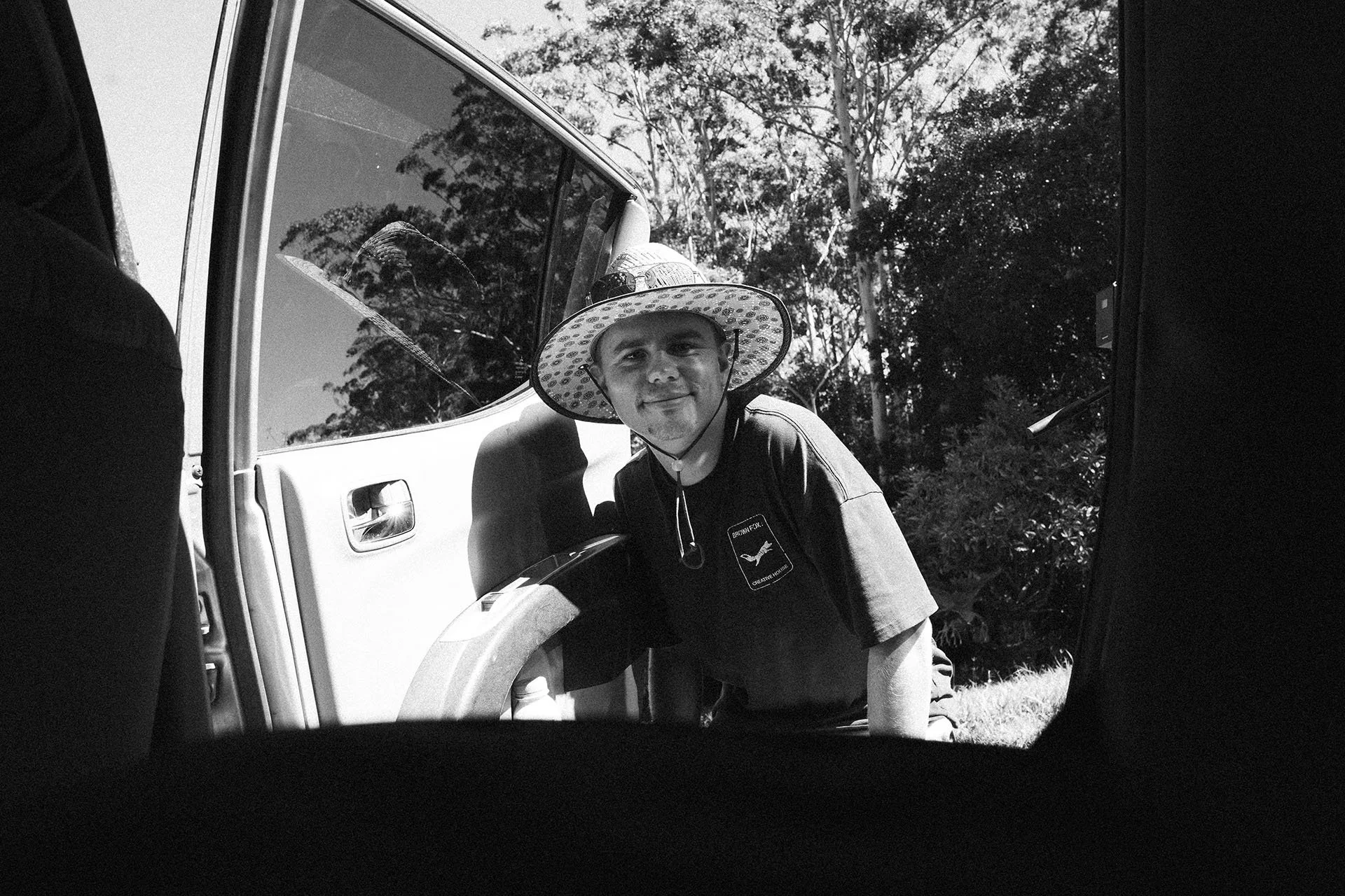 Brown Fox crew member wearing a wide-brim hat beside a production vehicle during the LSKD spec film shoot.