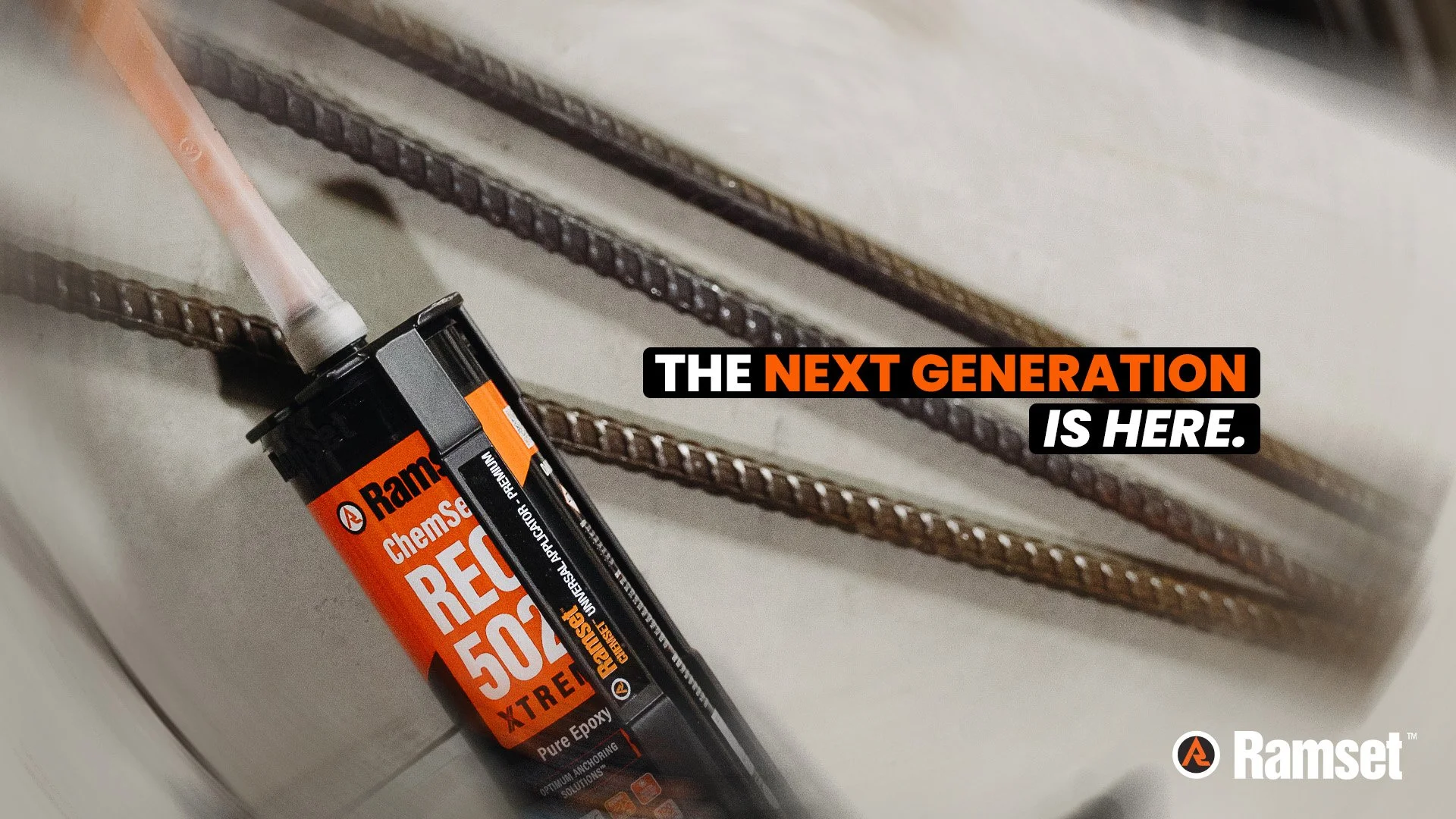 A tube of Ramset chemical anchor adhesive placed on a white surface with metal rebar in the background. The text on the image reads, 'The next generation is here.'