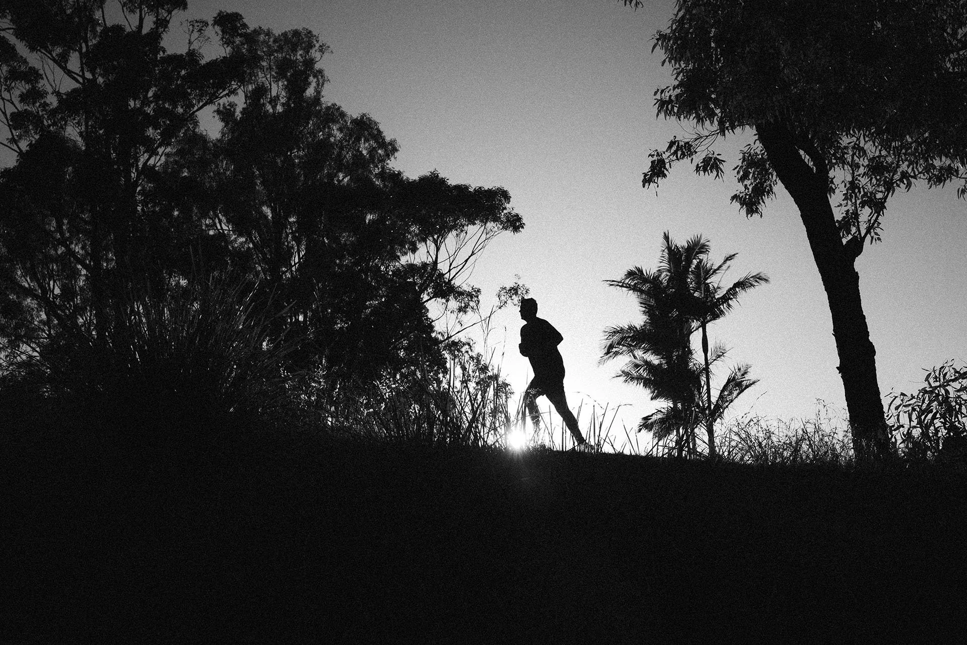 A monochrome production still from Brown Fox’s LSKD spec film, capturing the runner against the morning light.