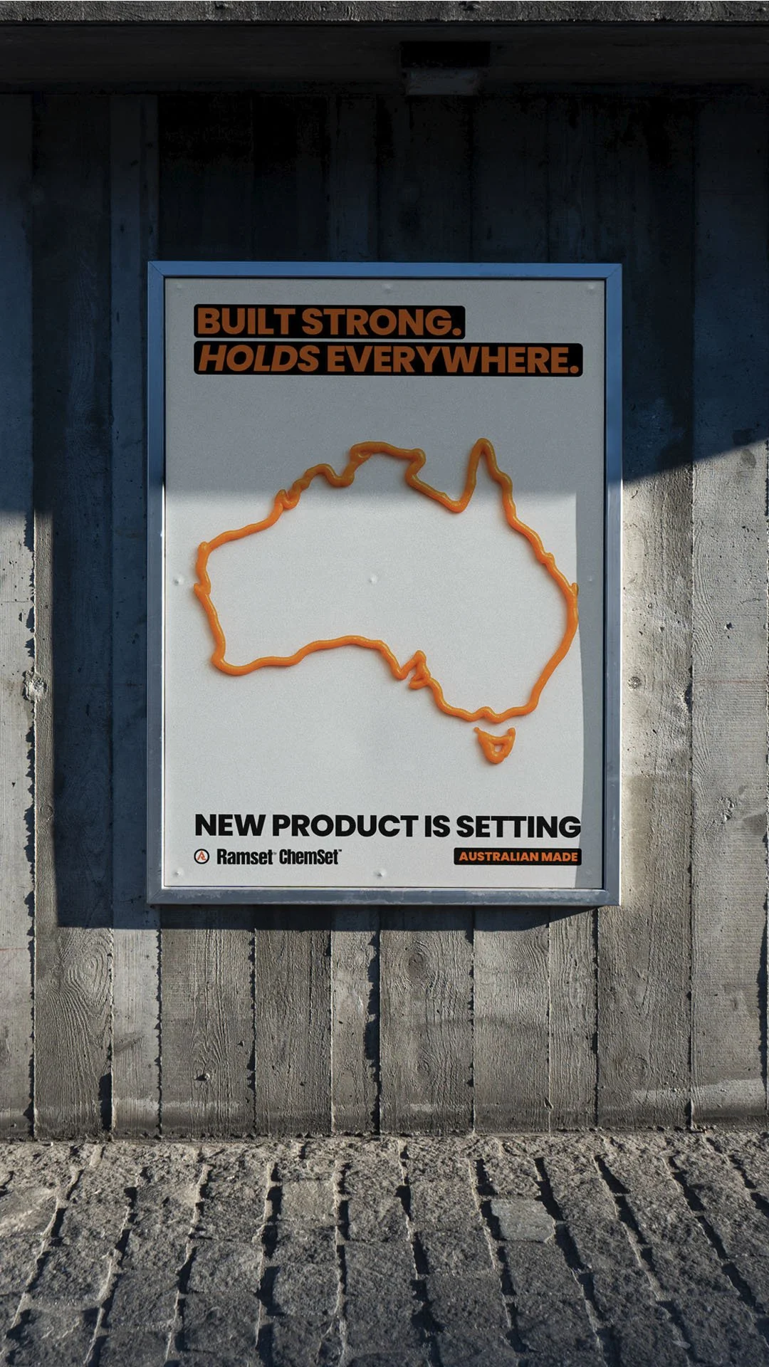A sign with a map of Australia outlined in orange and text promoting a new product, Ramset ChemSet, made in Australia. The top of the sign says 'Built Strong. Holds Everywhere.'