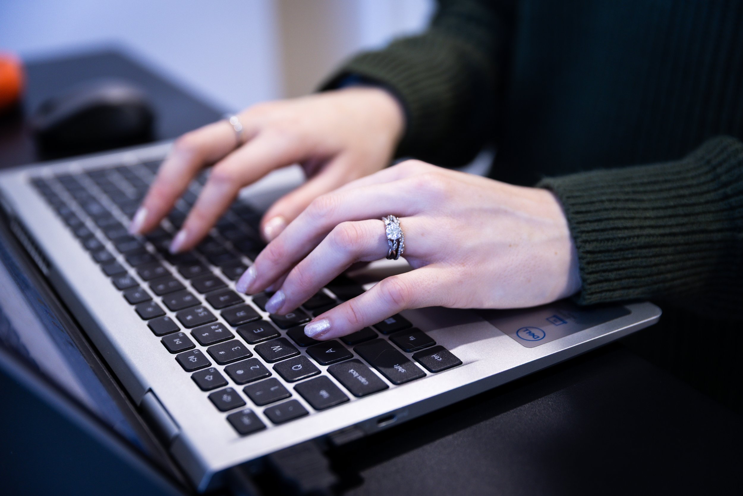 Britt McCarthy's hands typing on her laptop