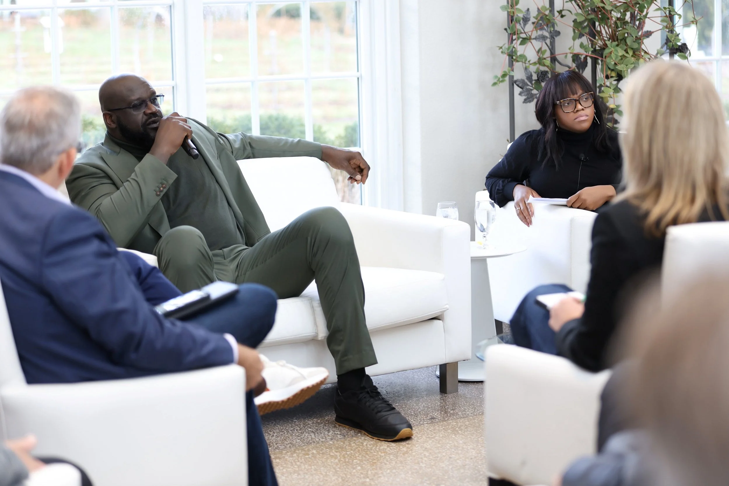 Diverse group of professionals discussing business in a bright office lounge