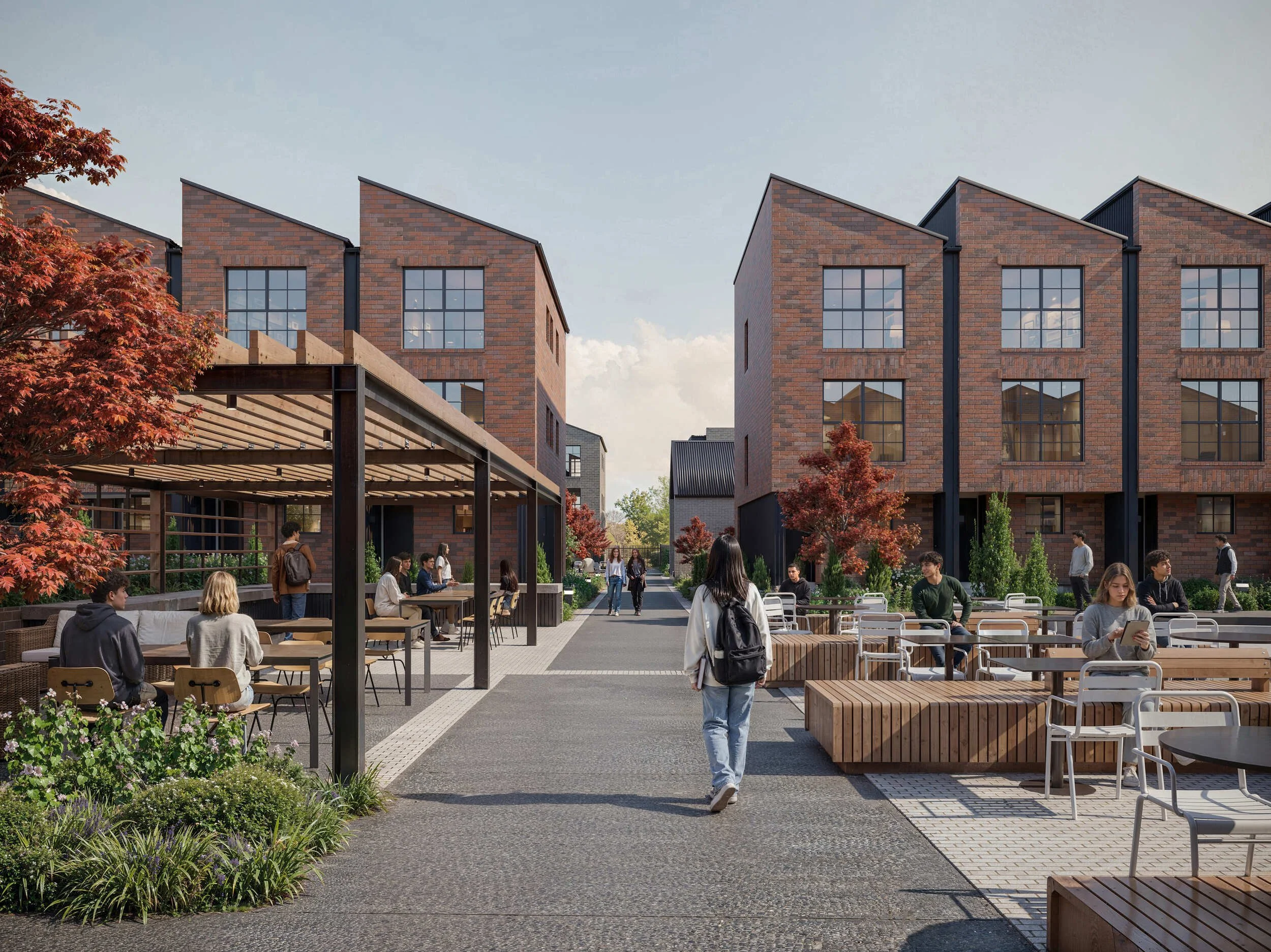 People walking and sitting in an outdoor courtyard with modern brick buildings in the background, trees, and outdoor furniture.