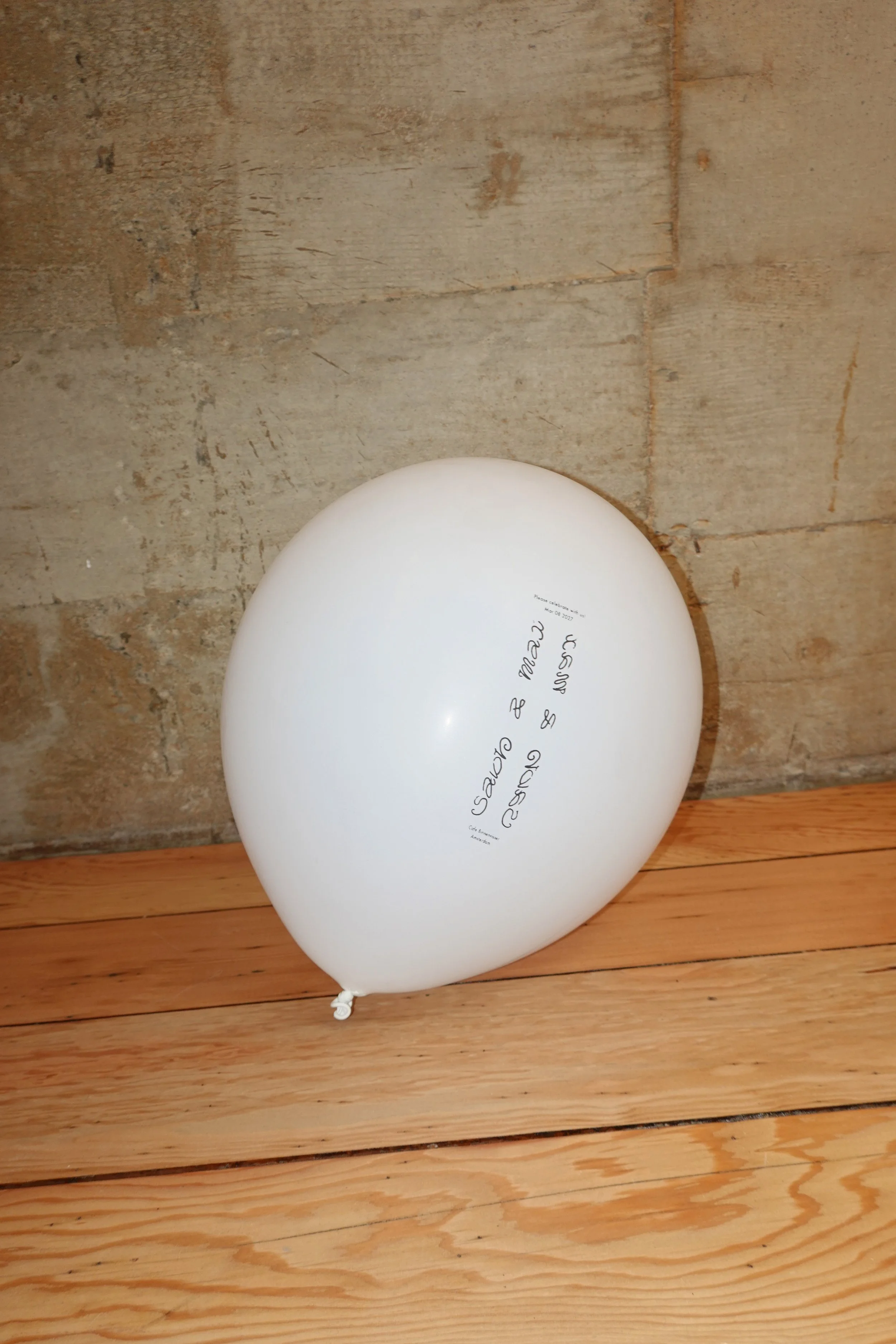 Invite balloon on wooden floor