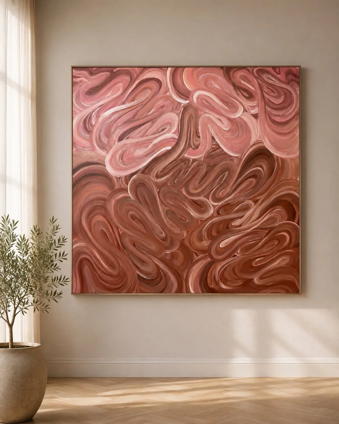 Abstract pink and brown swirling art on a square canvas hanging on a beige wall with a potted plant nearby.