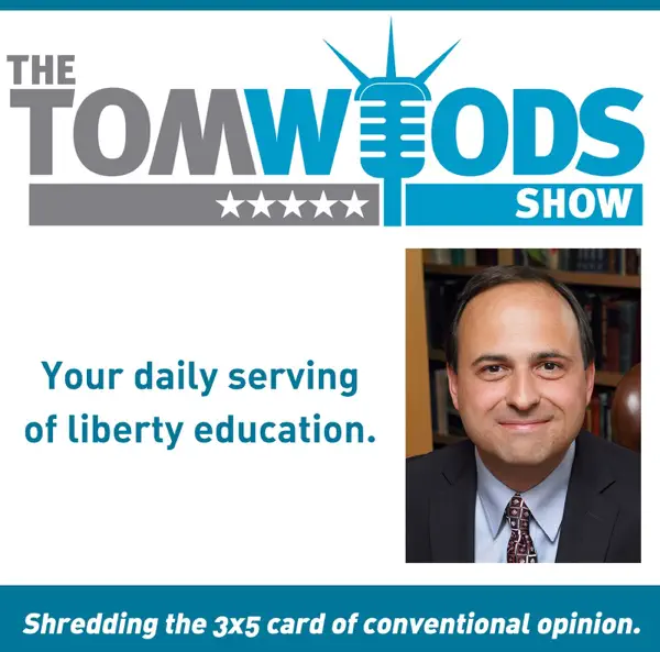 Logo for The Tom Woods Show featuring a microphone integrated in the 'W' of 'Woods' and five stars underneath. A slogan says, 'Your daily serving of liberty education.' The image includes a photo of Tom Woods, a man in a suit, next to the logo.