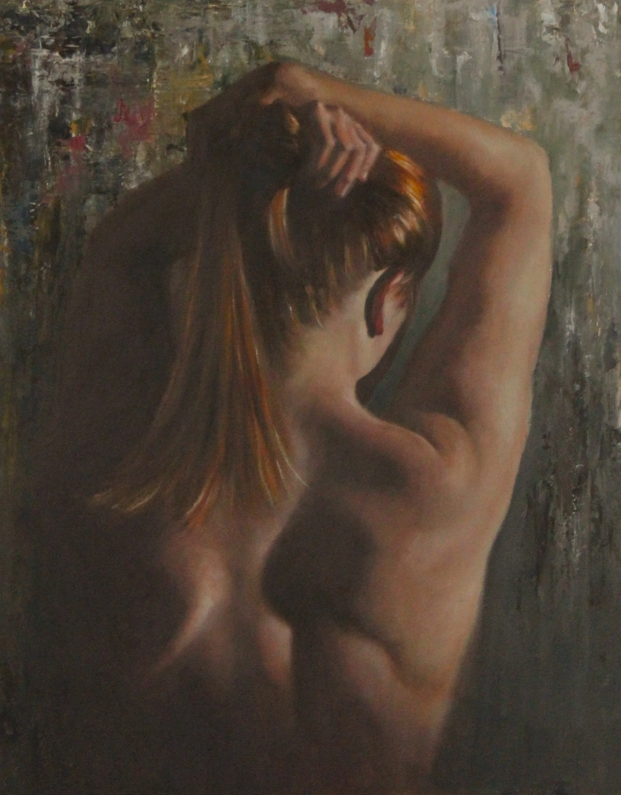 Back view of female dressing her hair