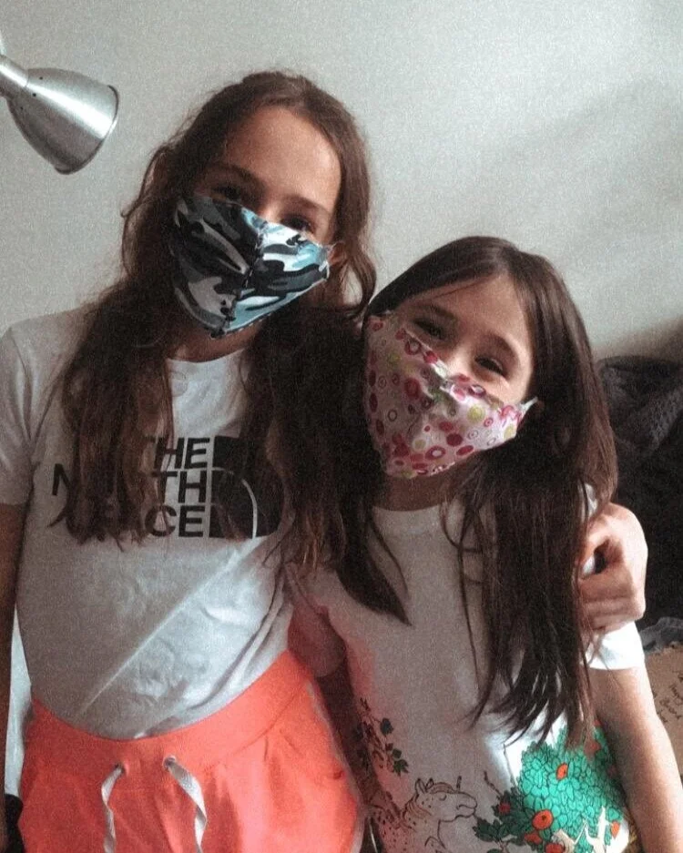 Children with their home-made masks from the sewing boxes created and delivered by volunteers during lockdown..