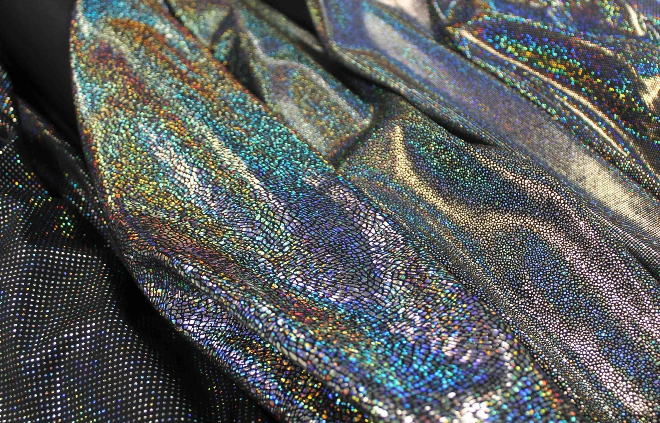 Various hologram designs in silver on black polyamide/elastane fabric, printed in Como, for dance, figure skating, artistic gymnastics, theatre and luxury lingerie