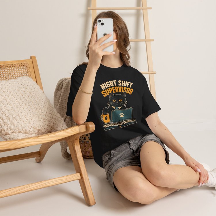 Model wearing the black Night Shift Supervisor cat T-shirt