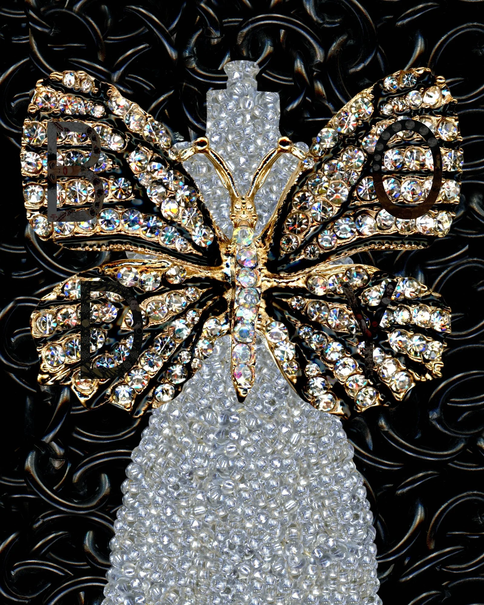 A decorative butterfly made of rhinestones and gold-colored metal on a black textured background.