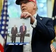 Trump displaying his photo with Putin in Alaska