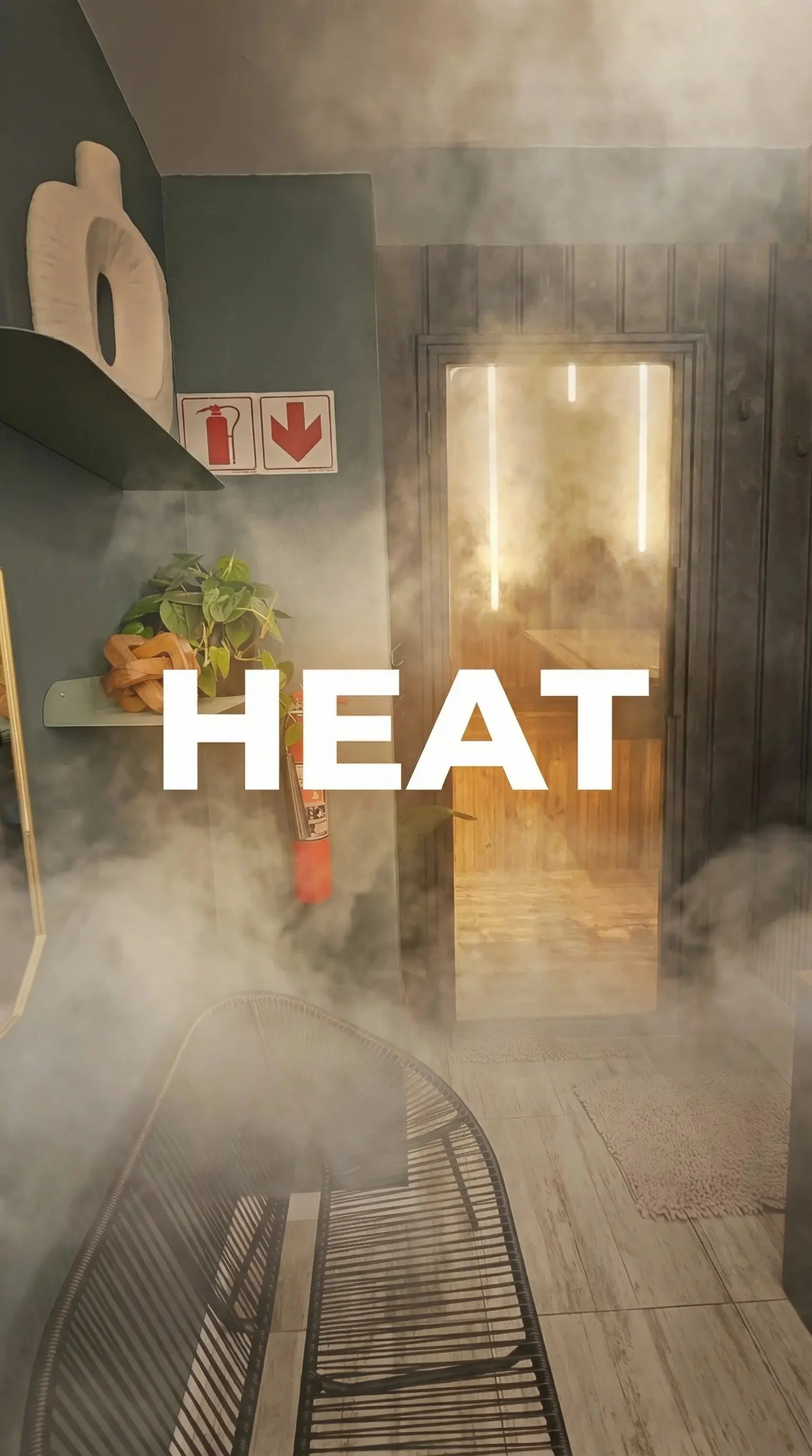 Steam rising in a room with interior decor, a bookshelf with a tissue box, a plant, a fire extinguisher, and a safety sign. The word 'HEAT' is written across the image.