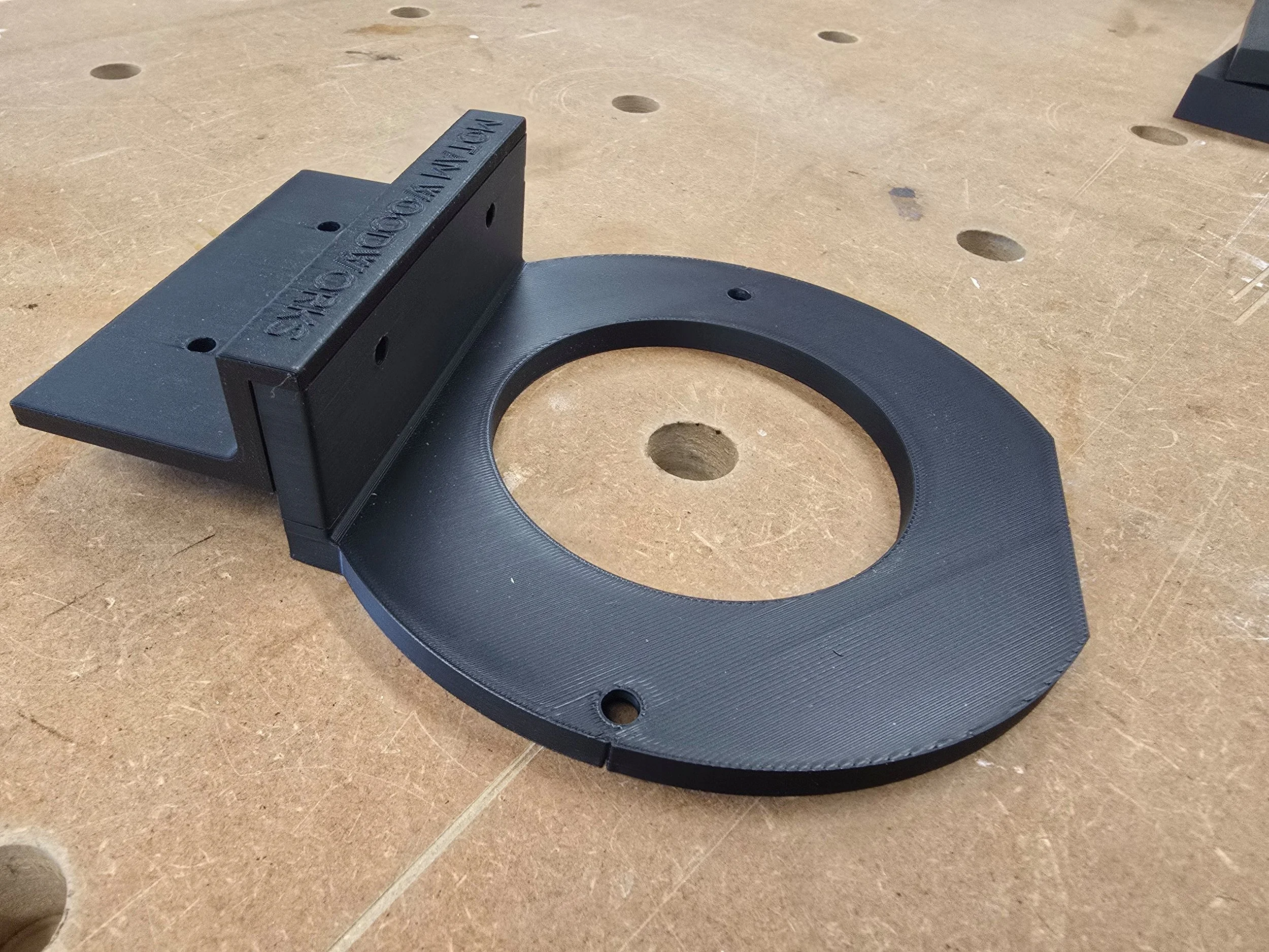 Motam Woodworks OF1400 router base and handle bracket, unattached, showing the mounting holes