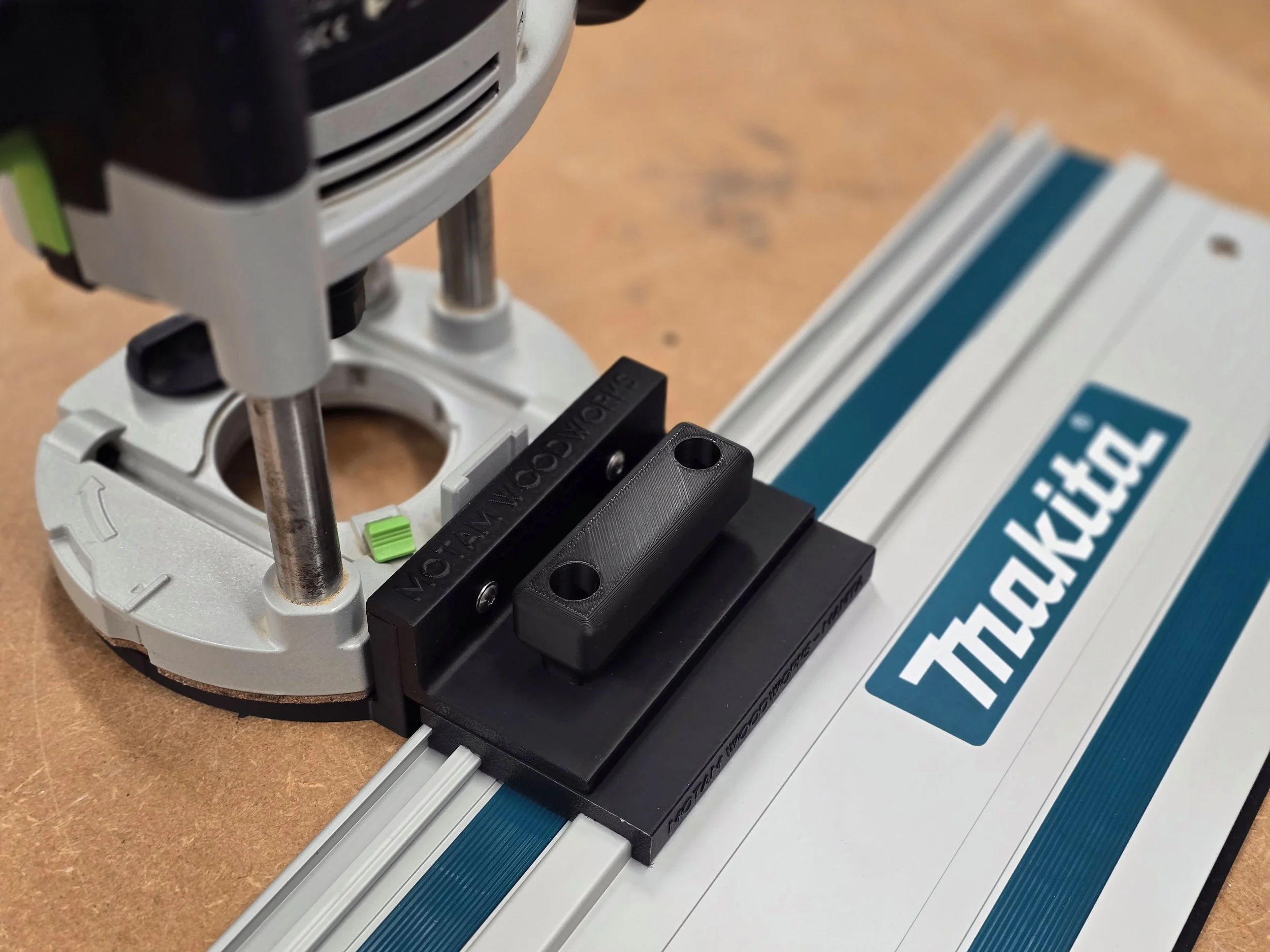 Router fitted with the Motam Woodworks base and handle, resting on a Makita guide rail