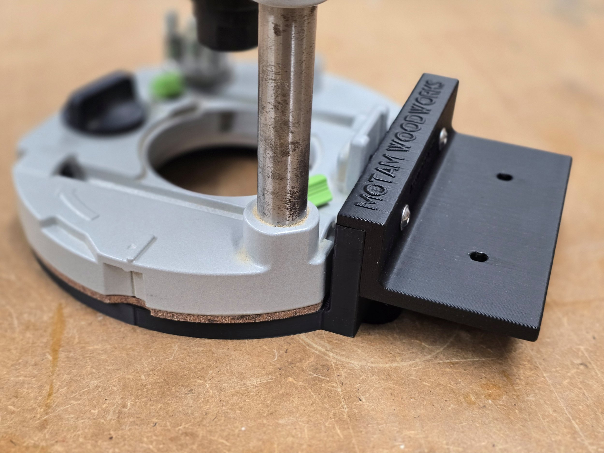 Close-up of the Motam Woodworks base fitted to the router's factory base ring