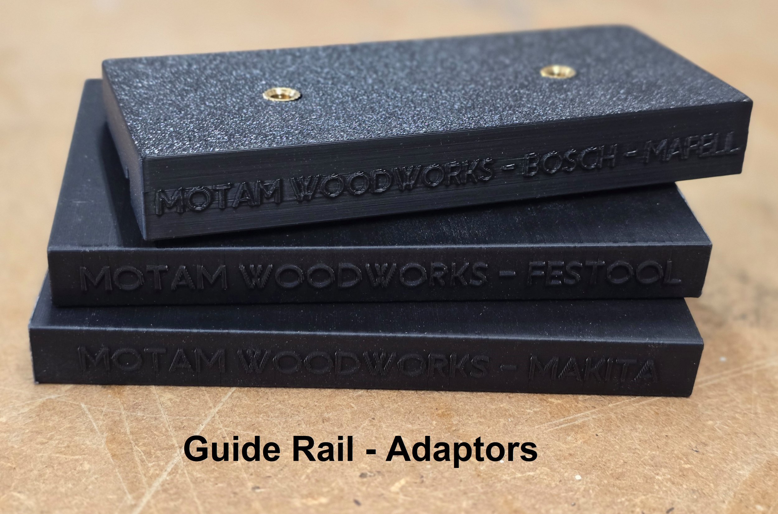 Three guide rail adaptor plates for Bosch-Mafell, Festool, and Makita stacked together