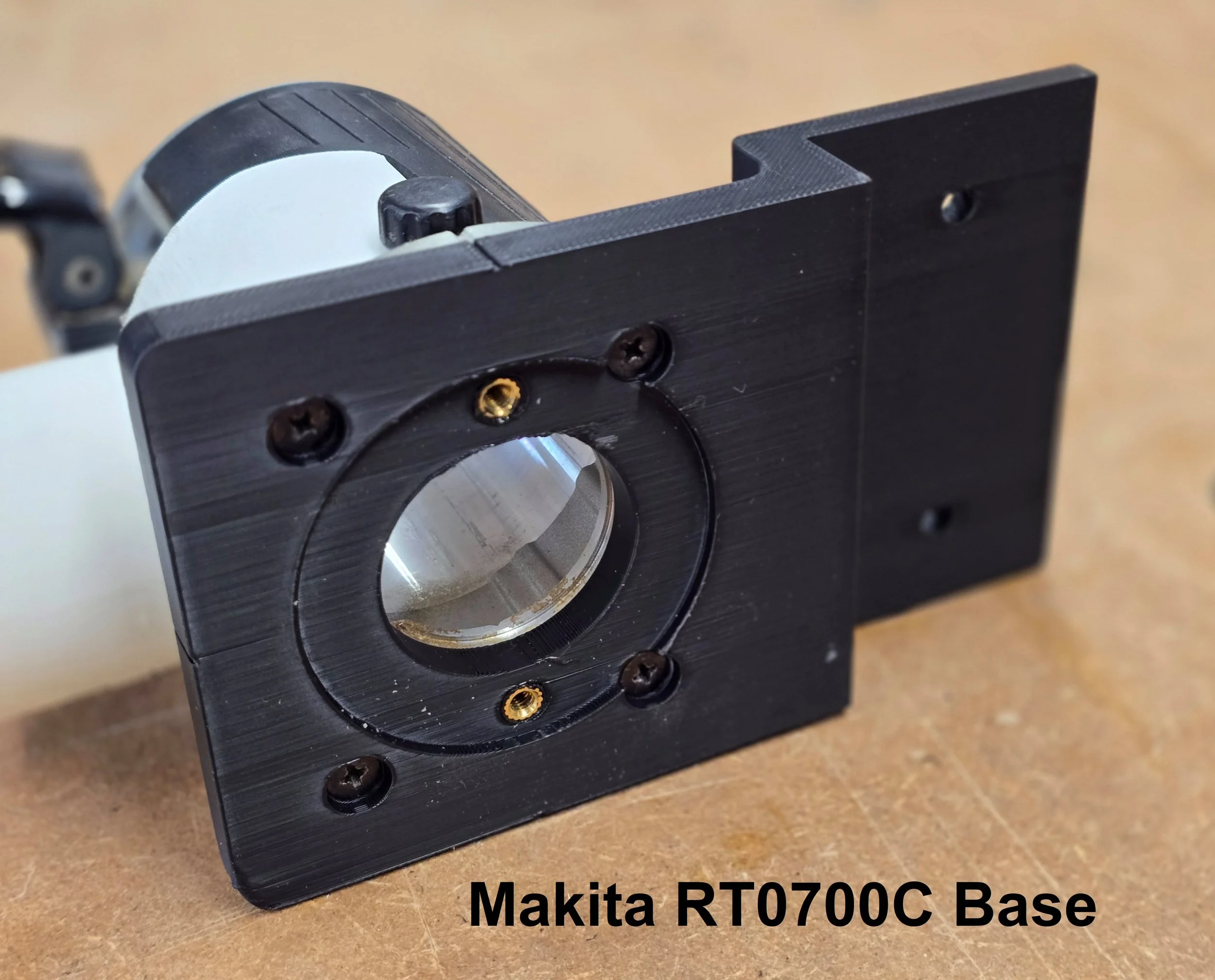 Makita RT0700C router fitted with its Motam Woodworks base plate