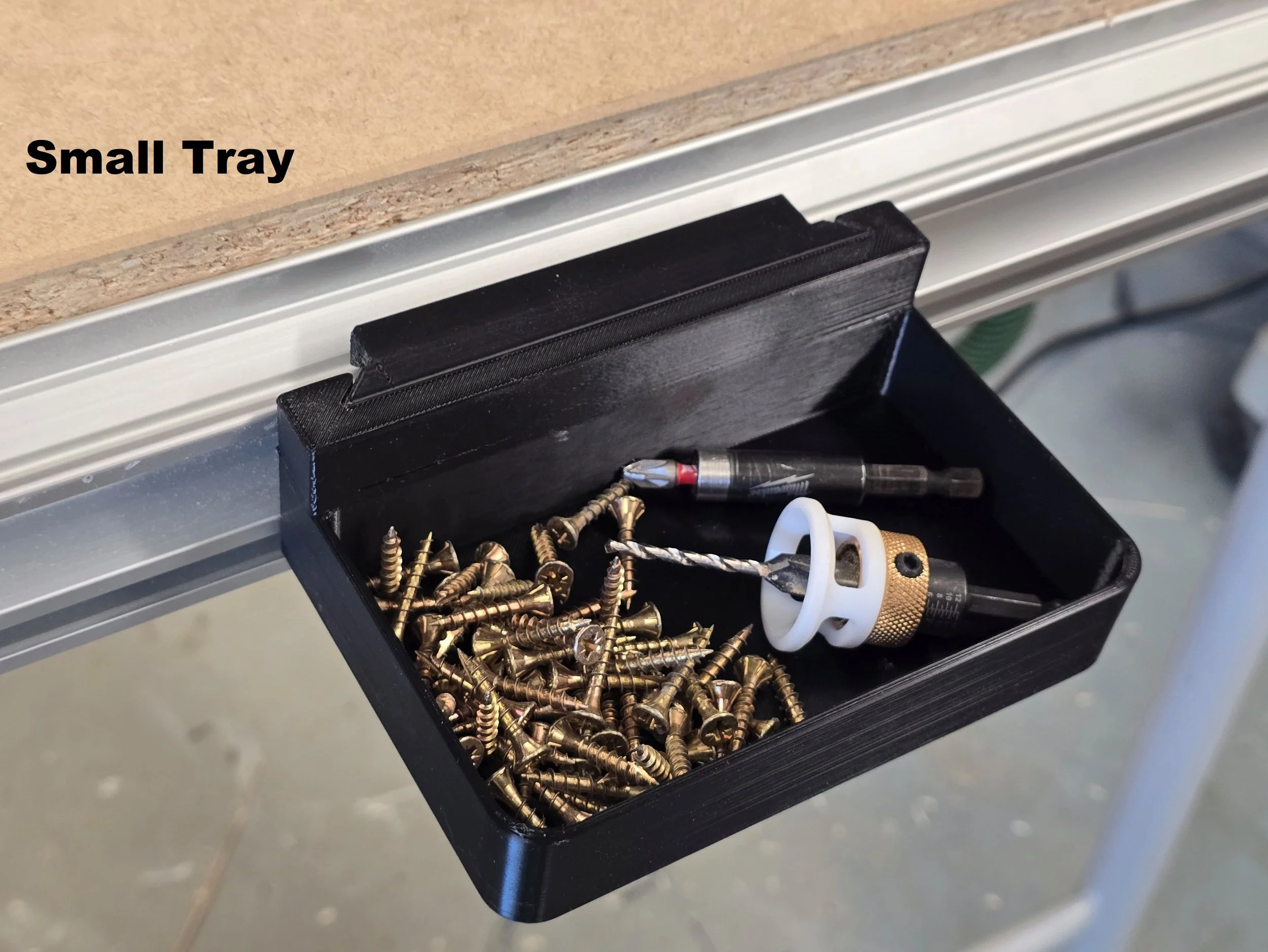 The Small Tray mount holding screws, drill bits, and a countersink bit