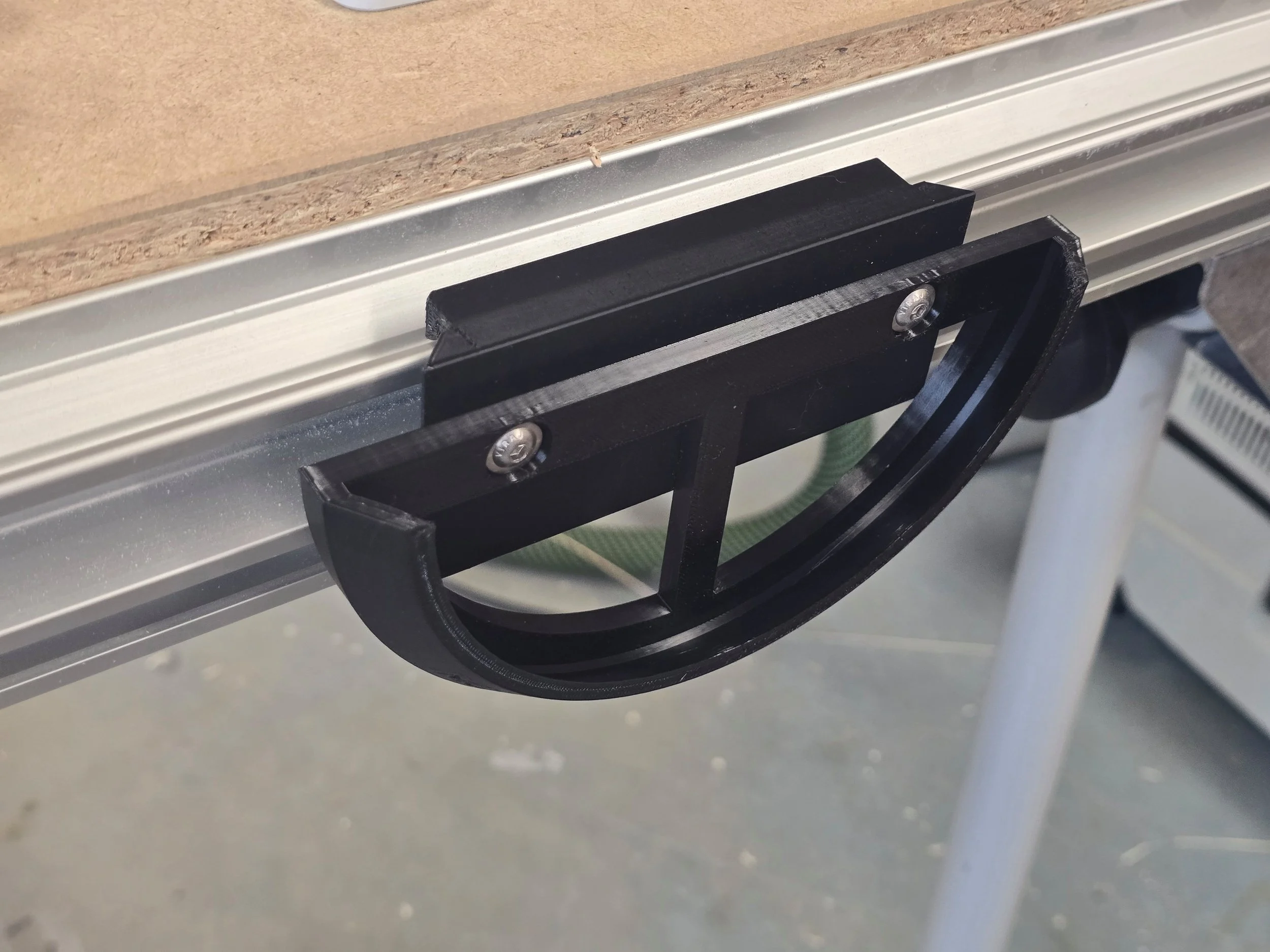 An empty half-moon sander mount fitted into an MFT table's T-track