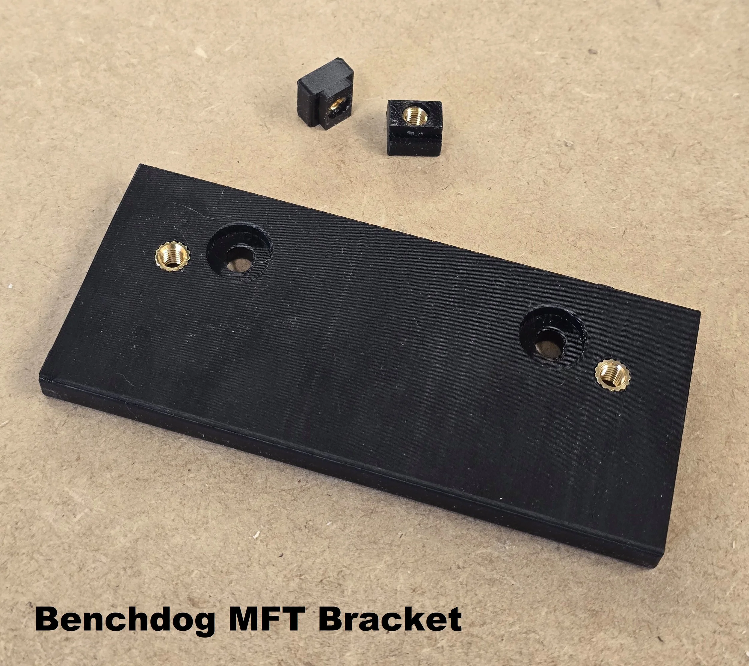 The Benchdog MFT Bracket base plate, unmounted, shown with its two T-slot nuts
