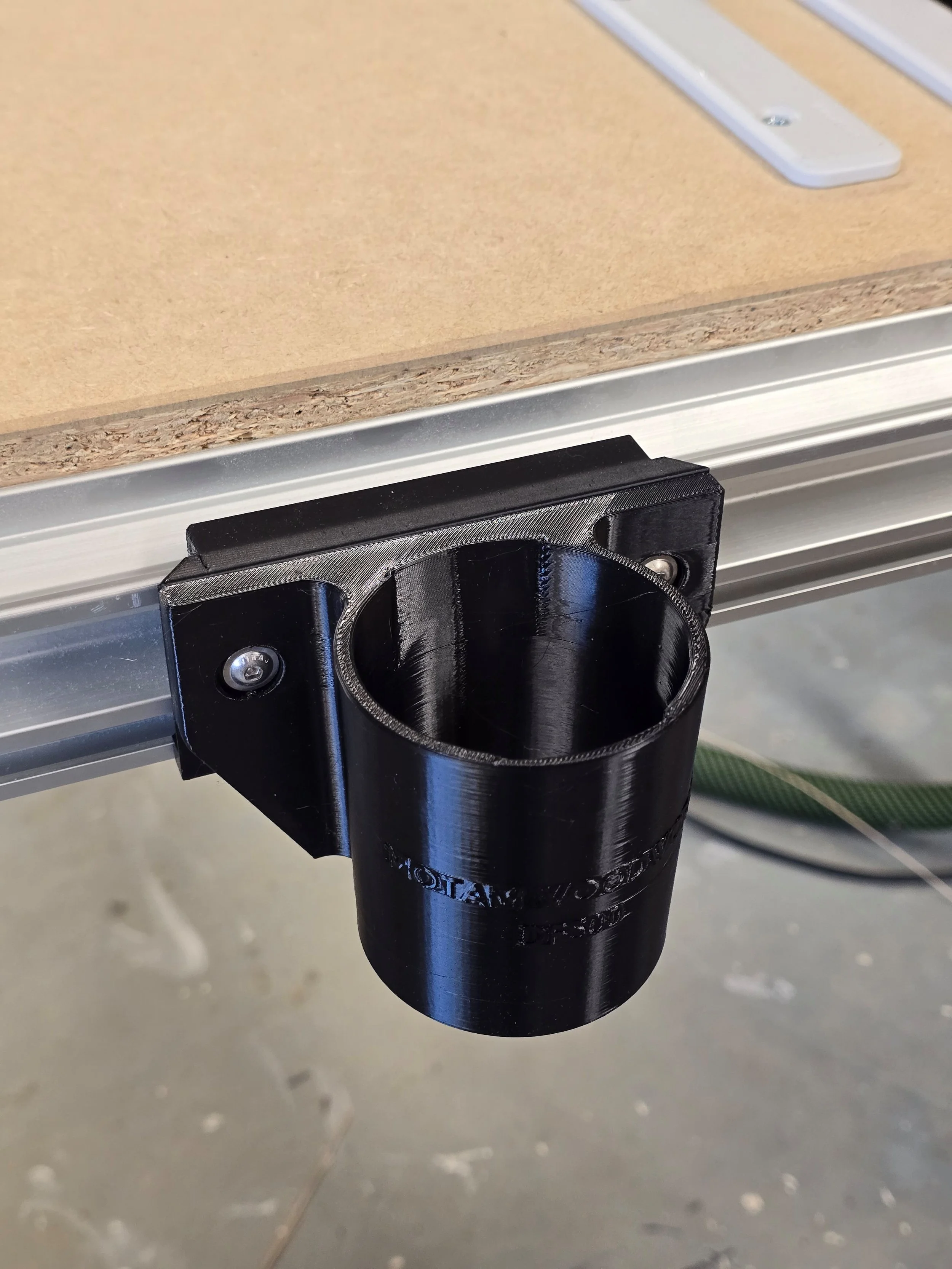 The Domino DF500 mount, embossed "Motam Woodworks DF500," fitted into an MFT table's T-track