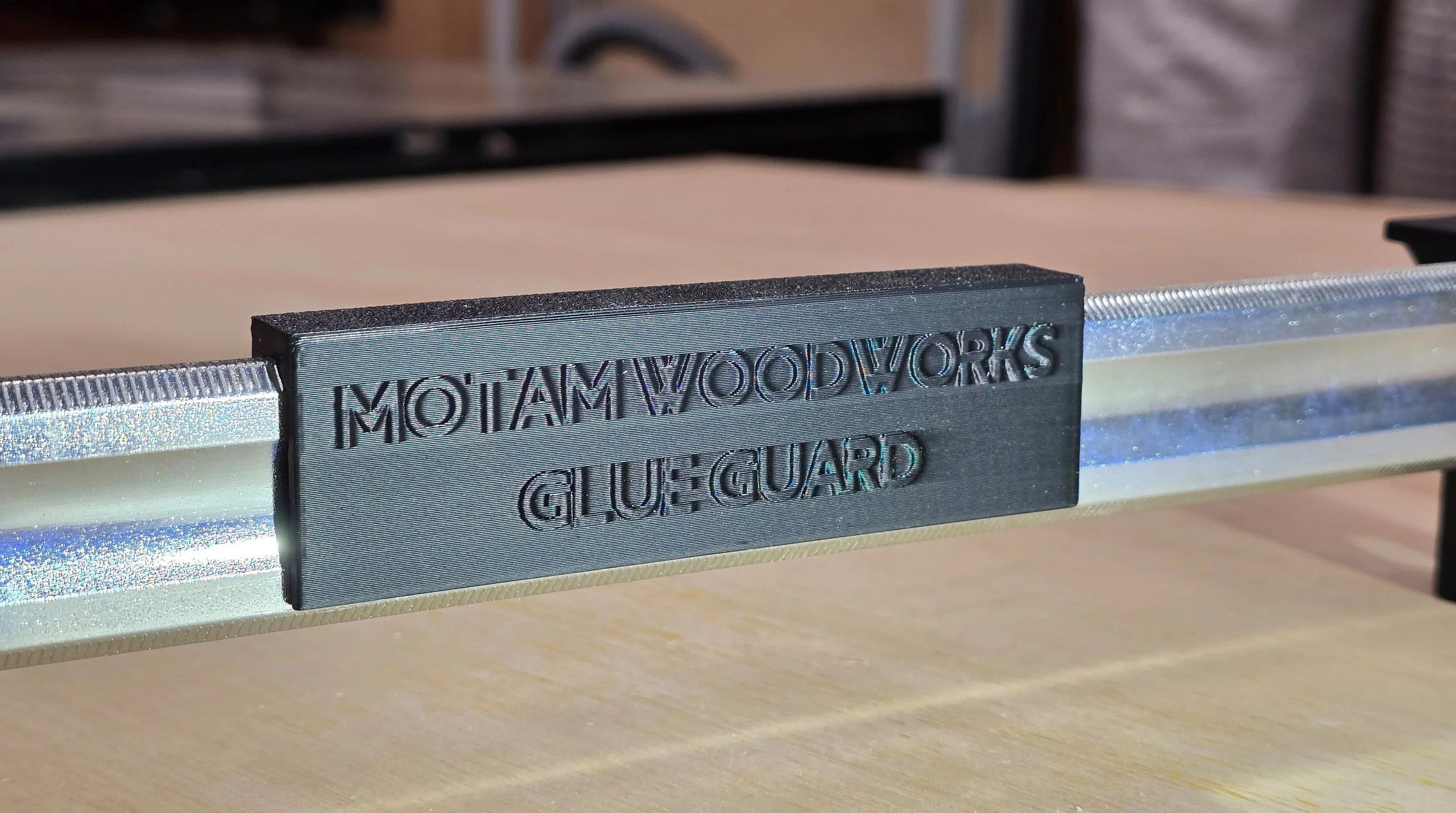 Extreme close-up of a single Glue Guard section snapped onto a clamp bar