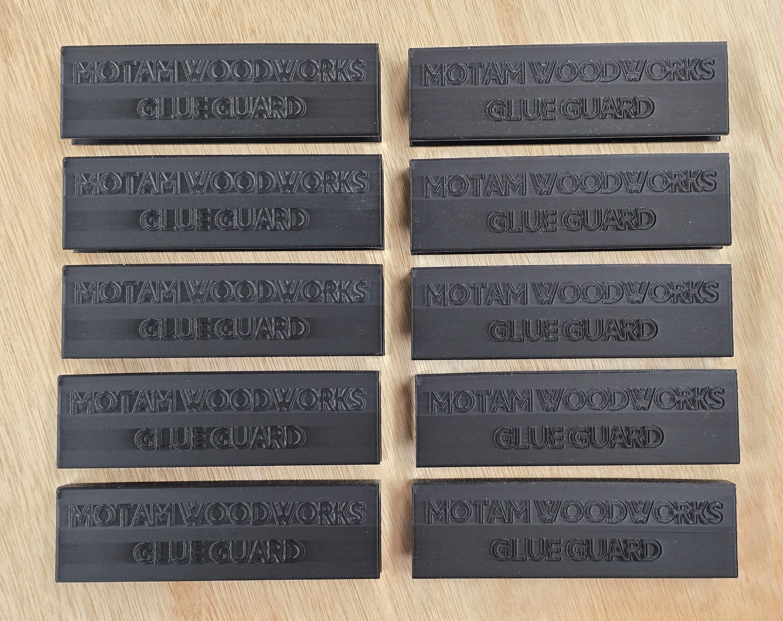 Ten Glue Guard sections laid out in two rows, each embossed "Motam Woodworks Glue Guard"