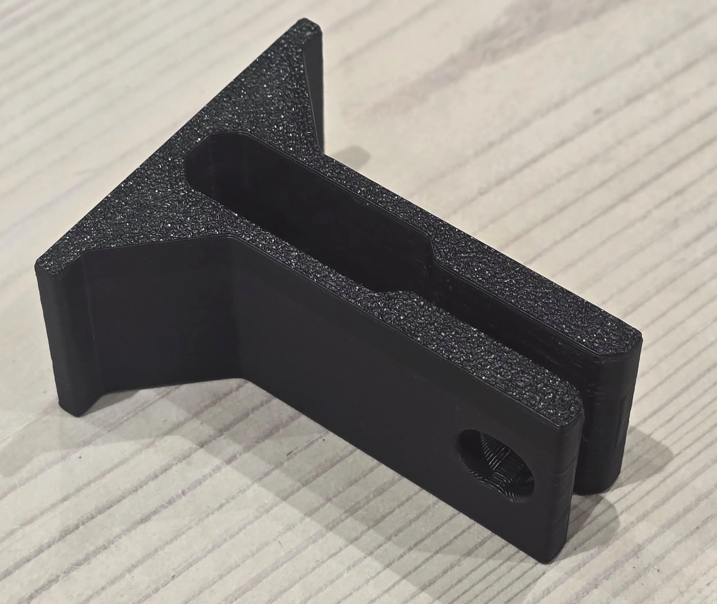 Close-up of a single bar protection clip, showing the channel that fits over the clamp bar