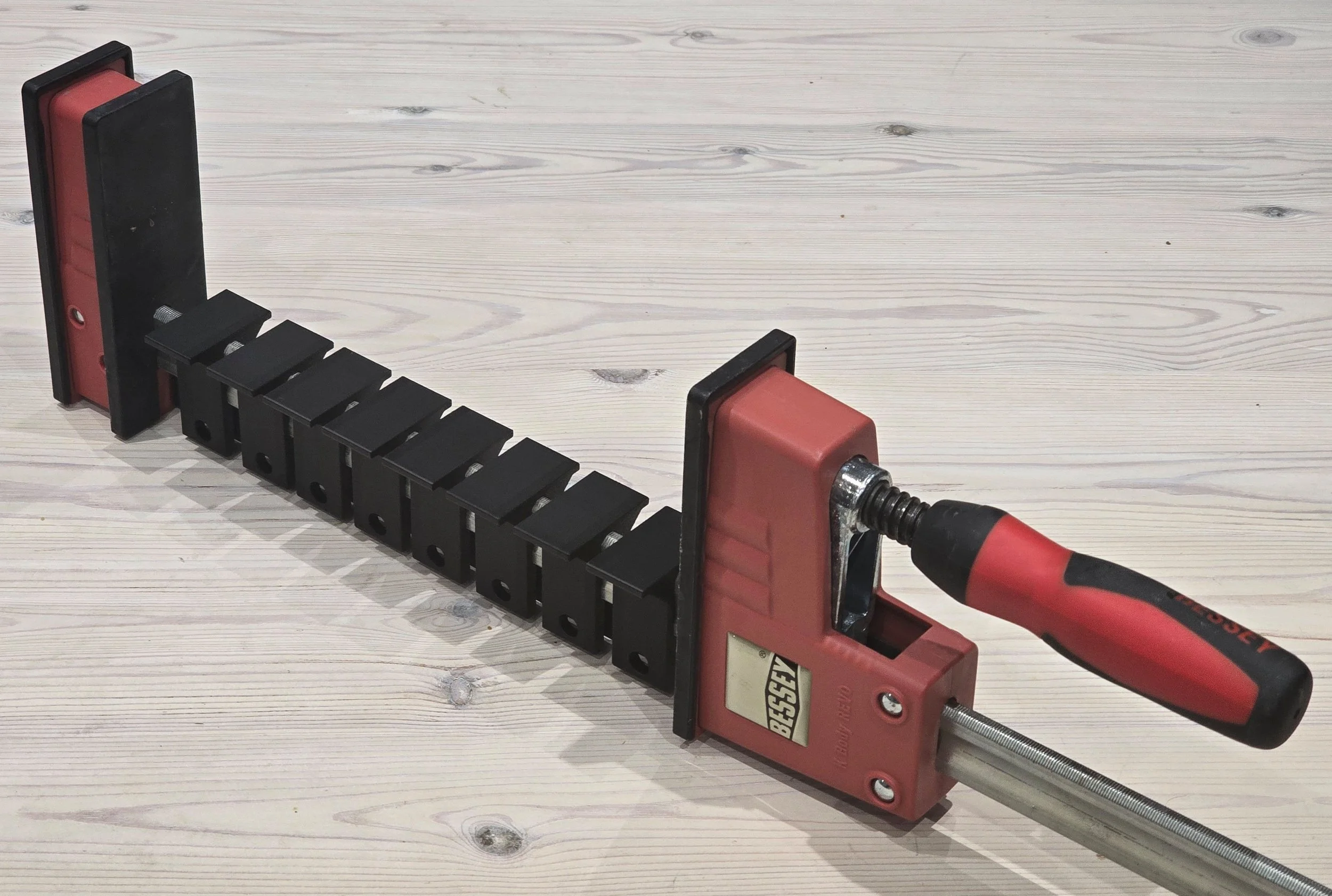 Eight bar protection clips fitted end-to-end along the full length of a Bessey K-Body REVO clamp bar