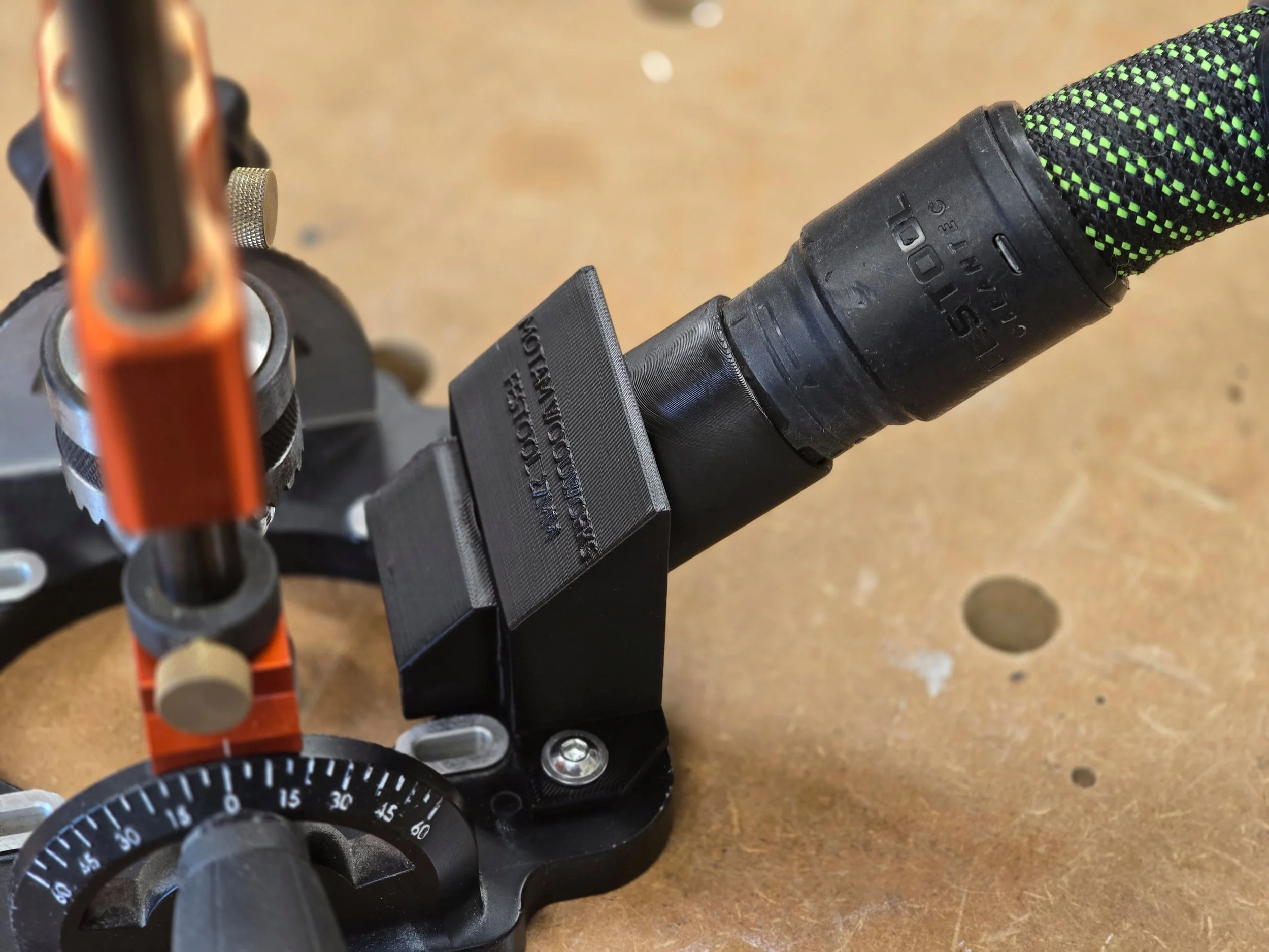 The dust adaptor mounted on a UJK Drill Guide with a Festool vacuum hose connected