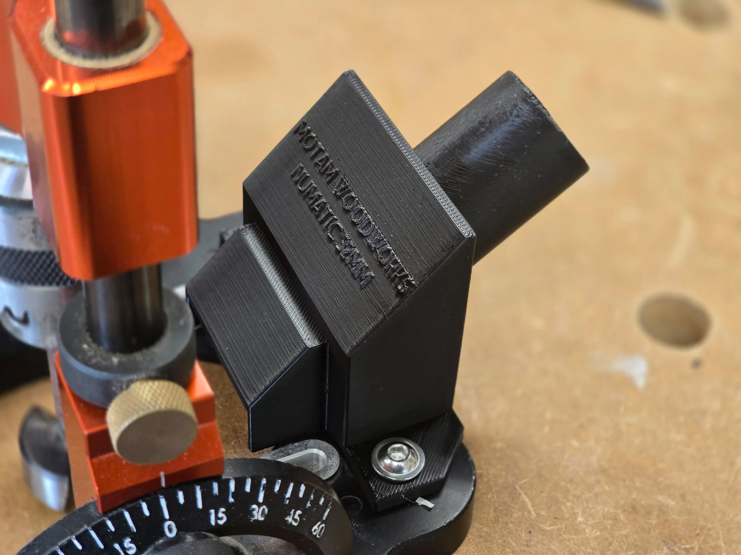 The dust adaptor mounted on a UJK Drill Guide, showing a wider vacuum port opening