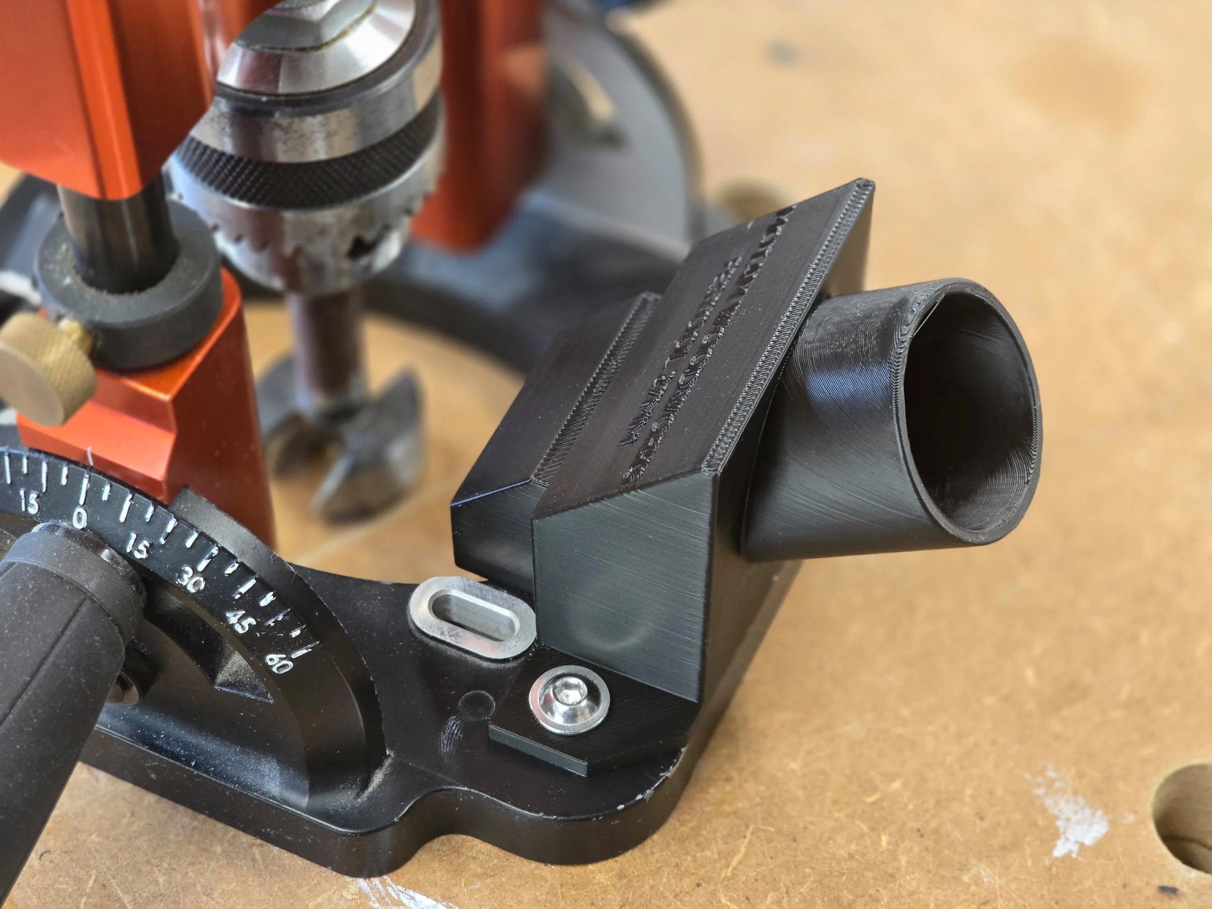 The dust adaptor mounted on a UJK Drill Guide, showing a wider vacuum port opening