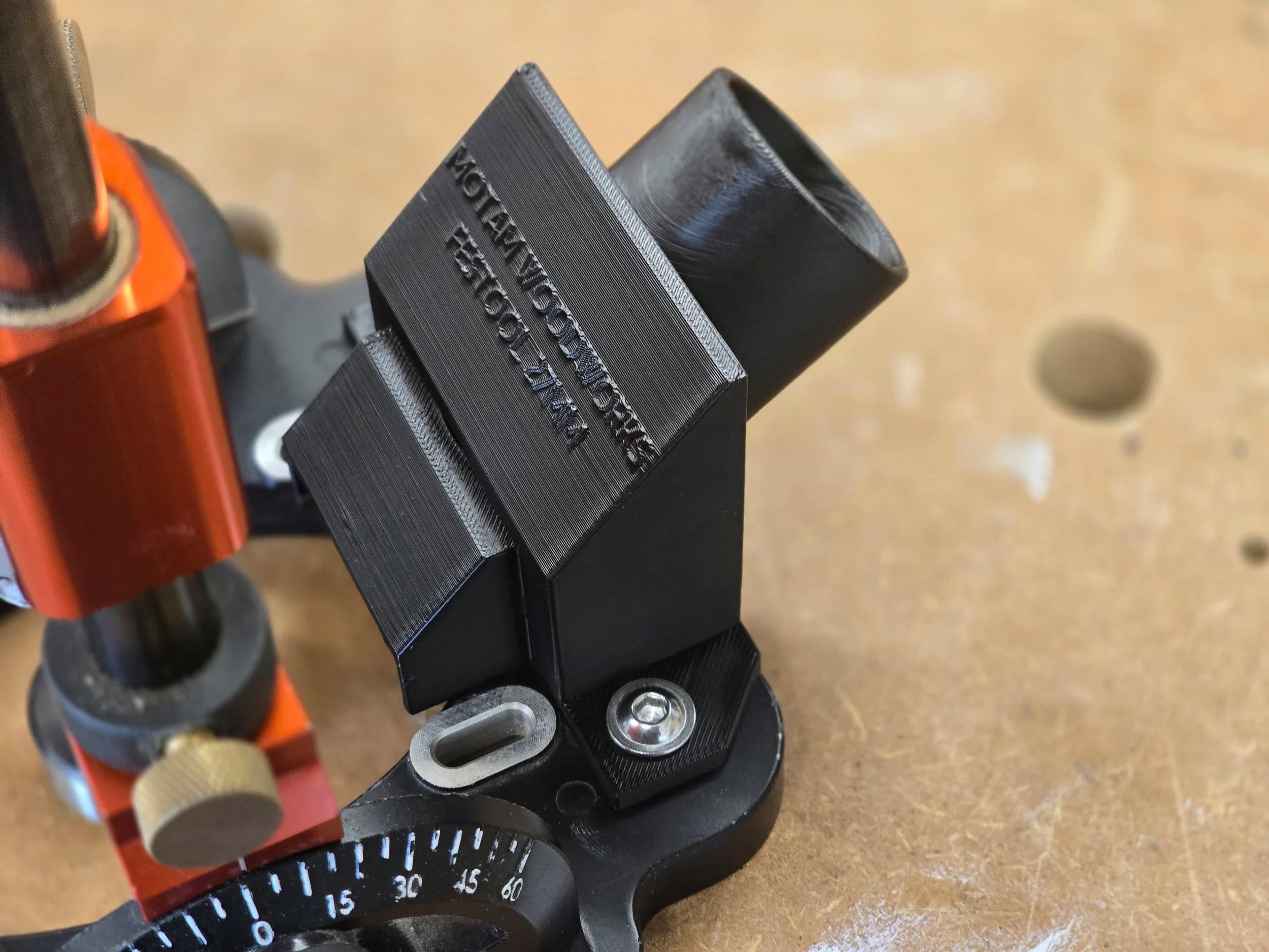 The dust adaptor mounted on a UJK Drill Guide, showing a wider vacuum port opening
