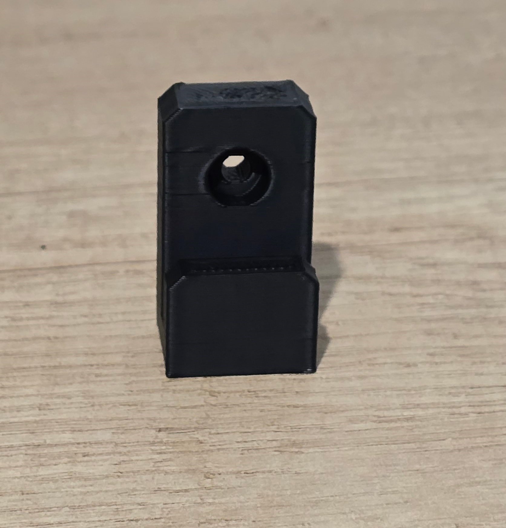 A single unmounted wall mount bracket, showing the screw hole and blade slot