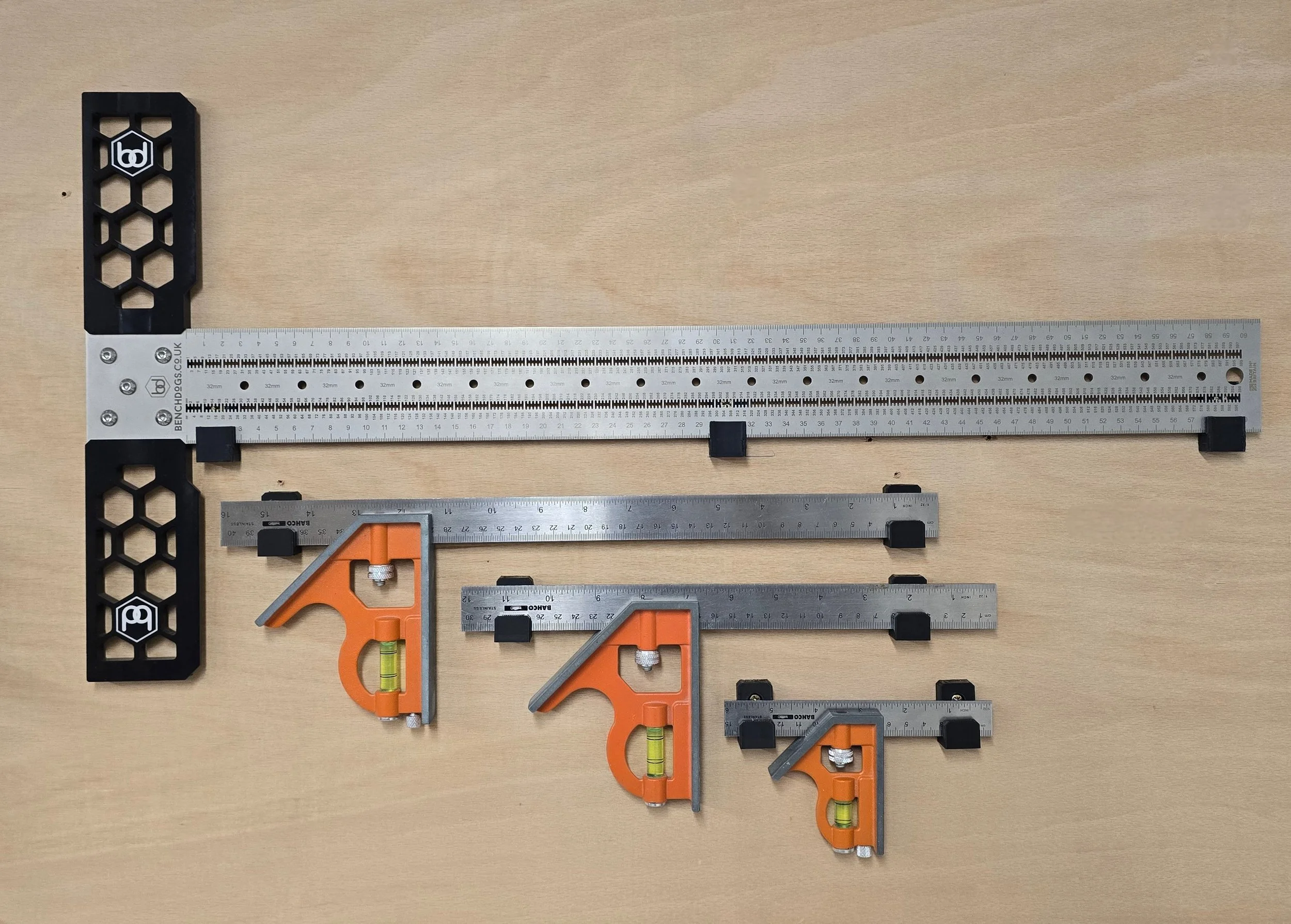 A Bench Dogs T-square and three Bahco combination squares of decreasing size, each fitted with wall mount brackets