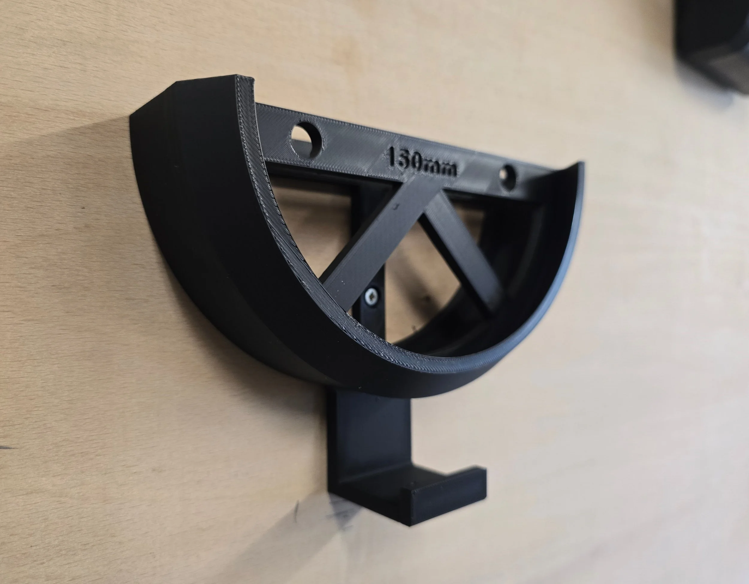 An empty 150mm wall mount bracket with an integrated cable hook, embossed "Motam Woodworks 150mm"