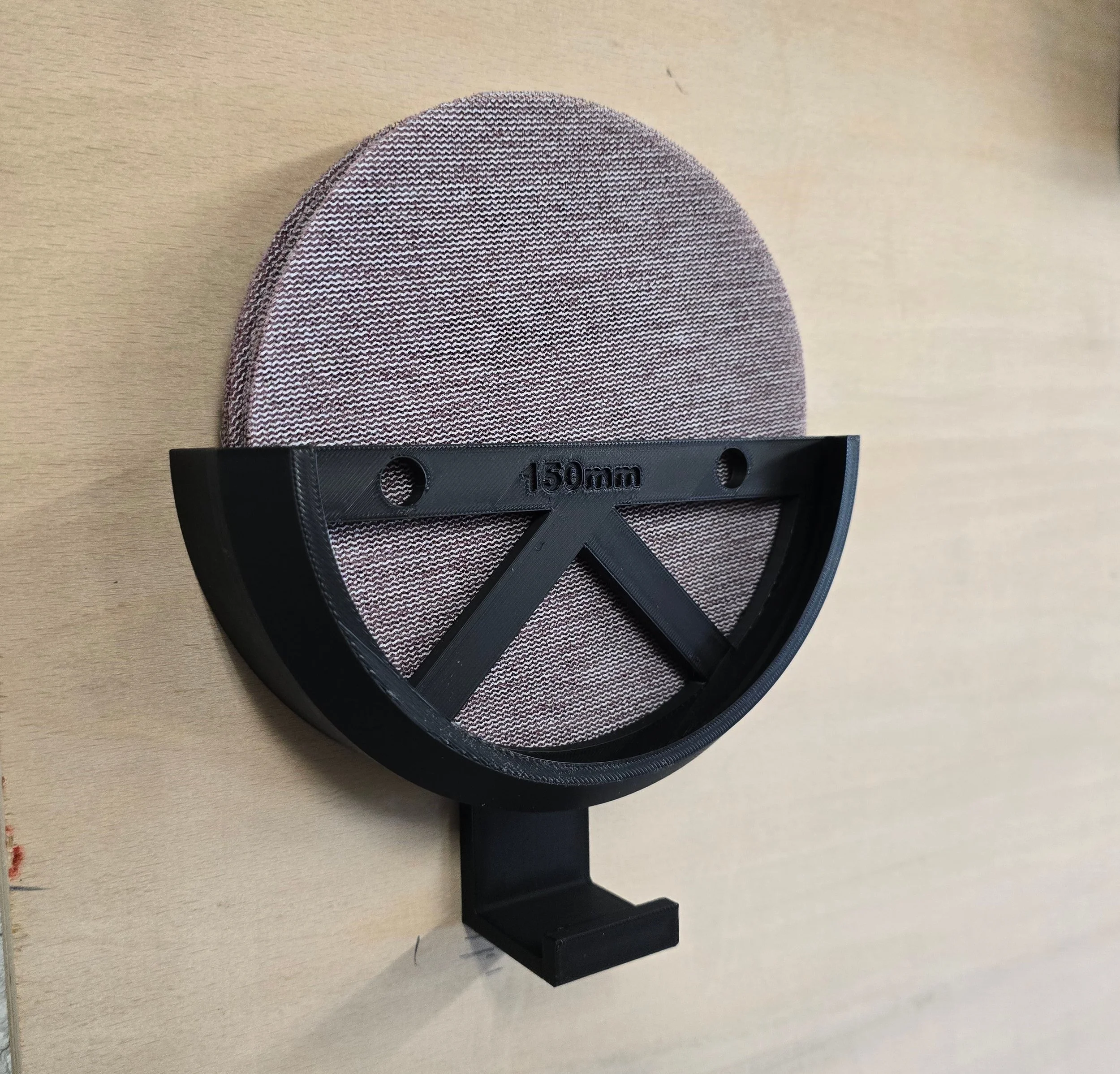 Front view of the 150mm bracket holding sanding discs and a coiled mains cable