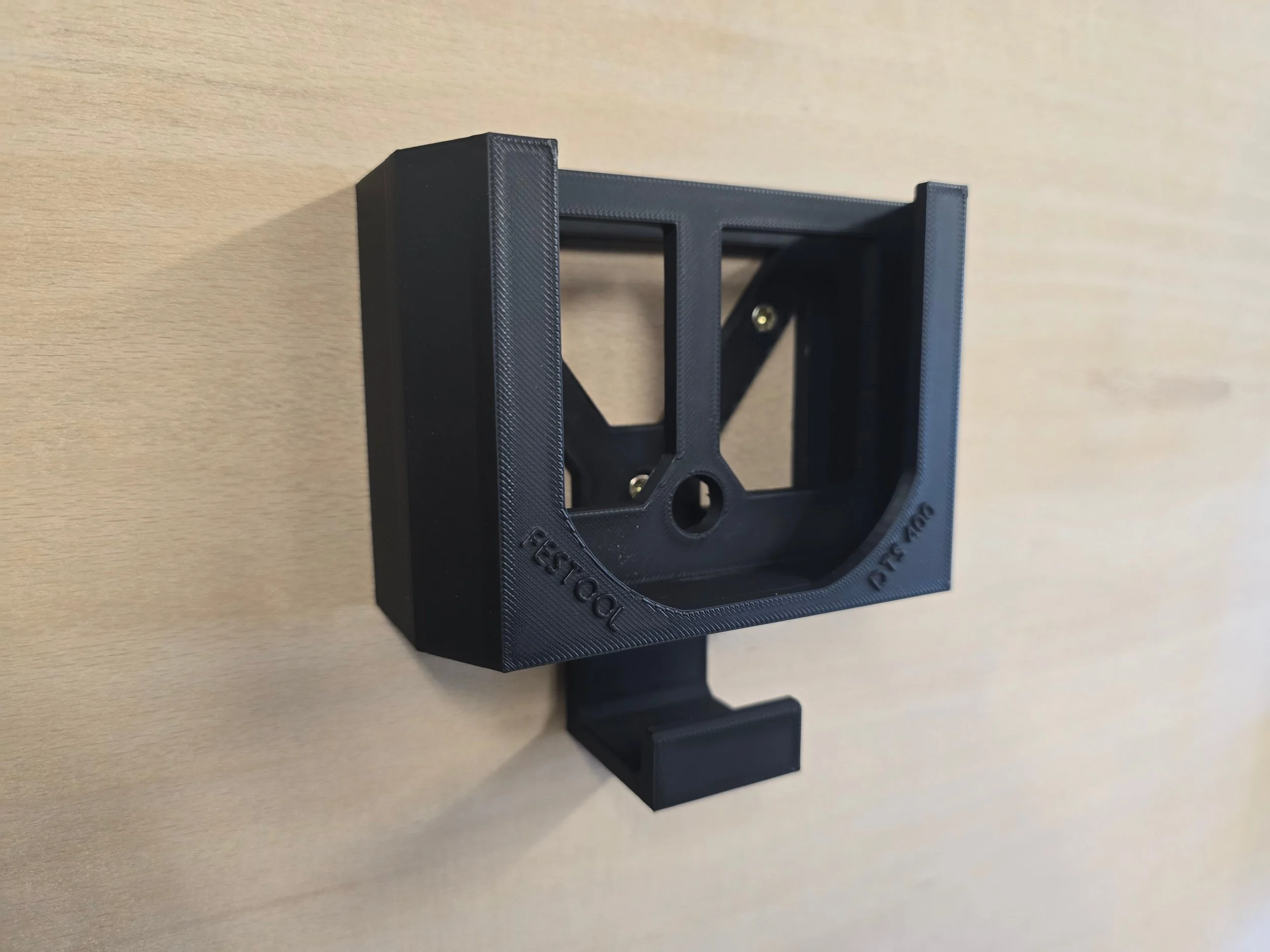 An empty Festool DTS 400 wall mount bracket with an integrated cable hook, embossed "Festool DTS 400"