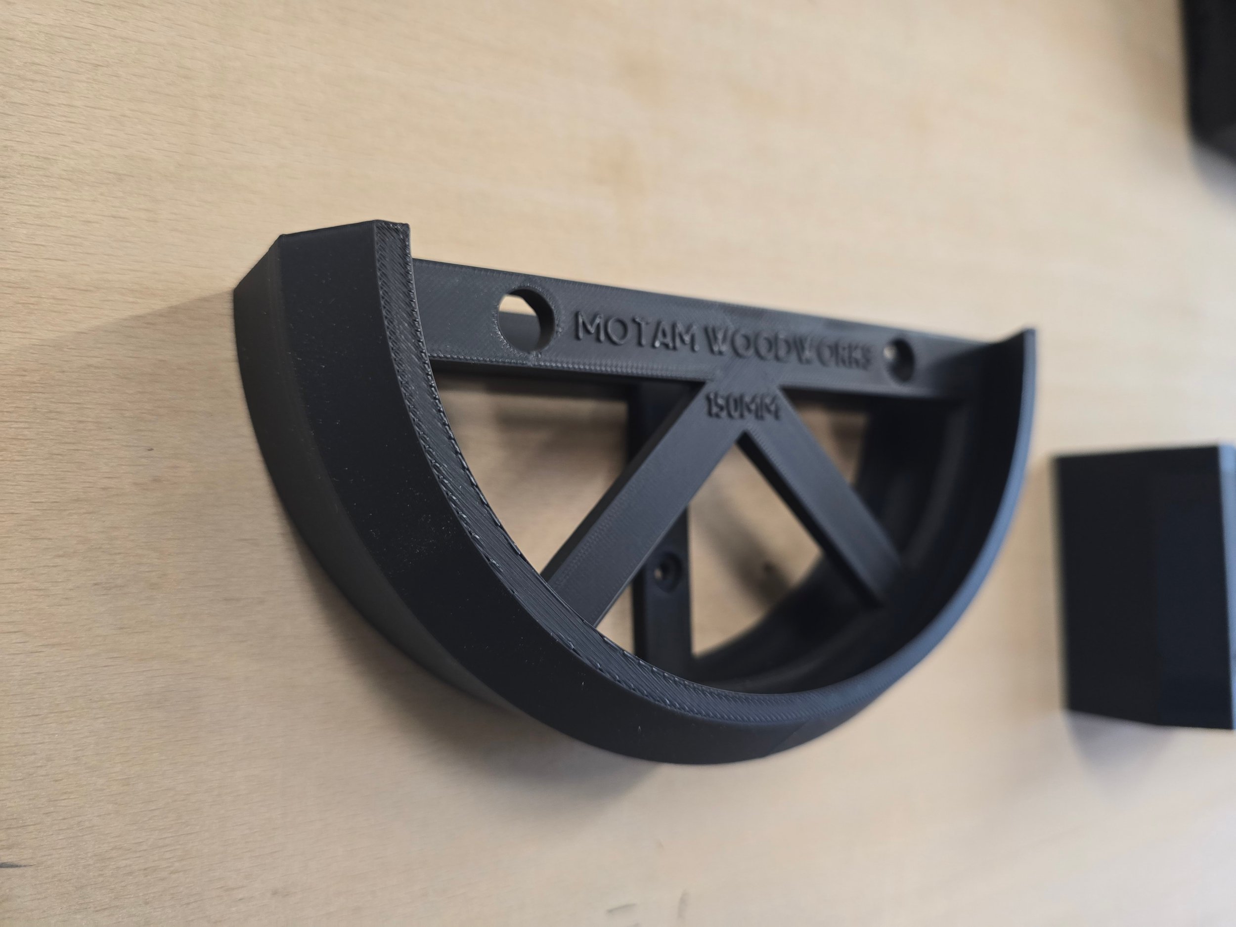 An empty 150mm wall mount bracket, embossed "Motam Woodworks 150mm"