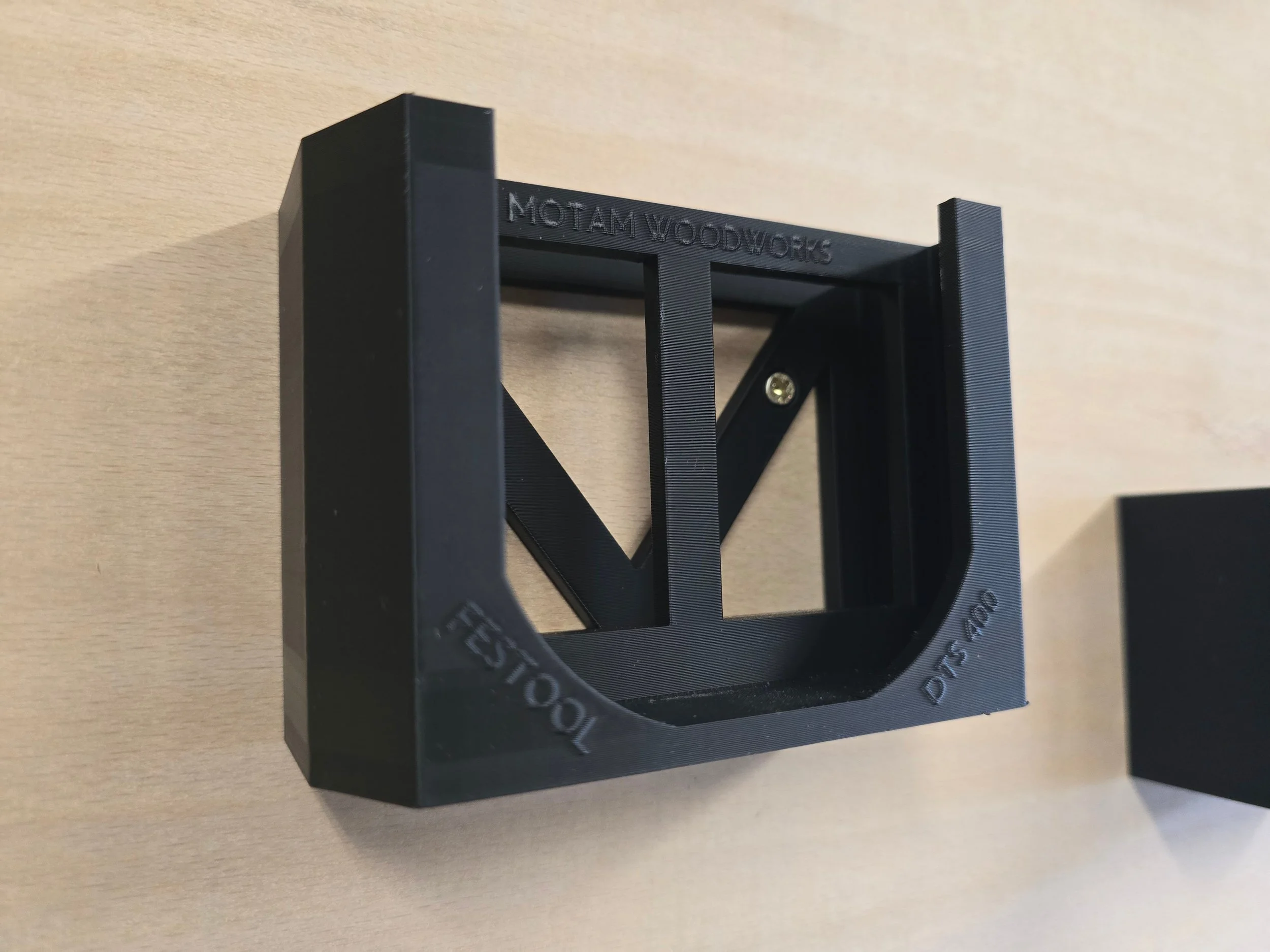 An empty Festool DTS 400 wall mount bracket, embossed "Festool DTS 400"
