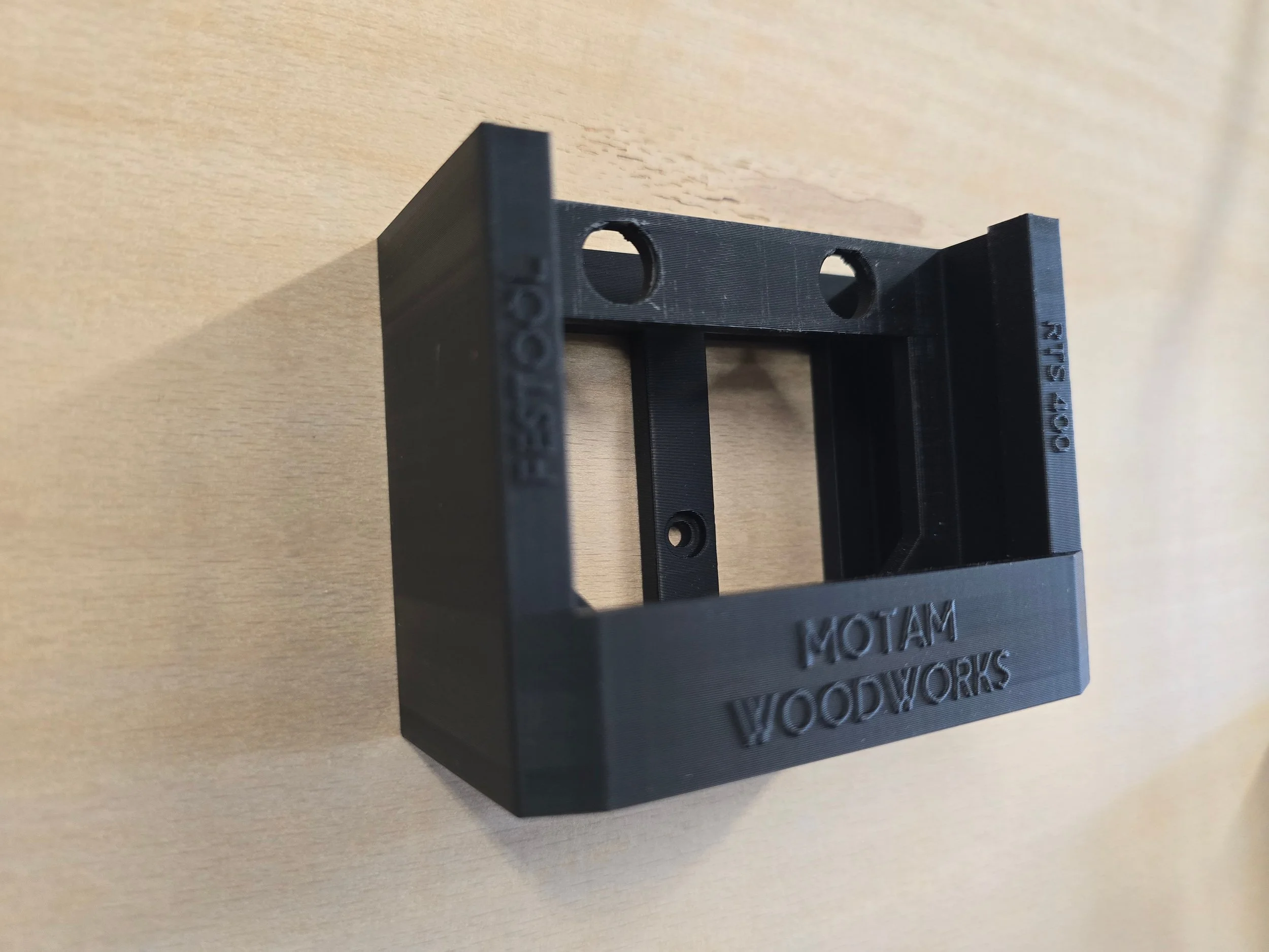 An empty Festool RTS 400 wall mount bracket, embossed "Festool RTS 400"