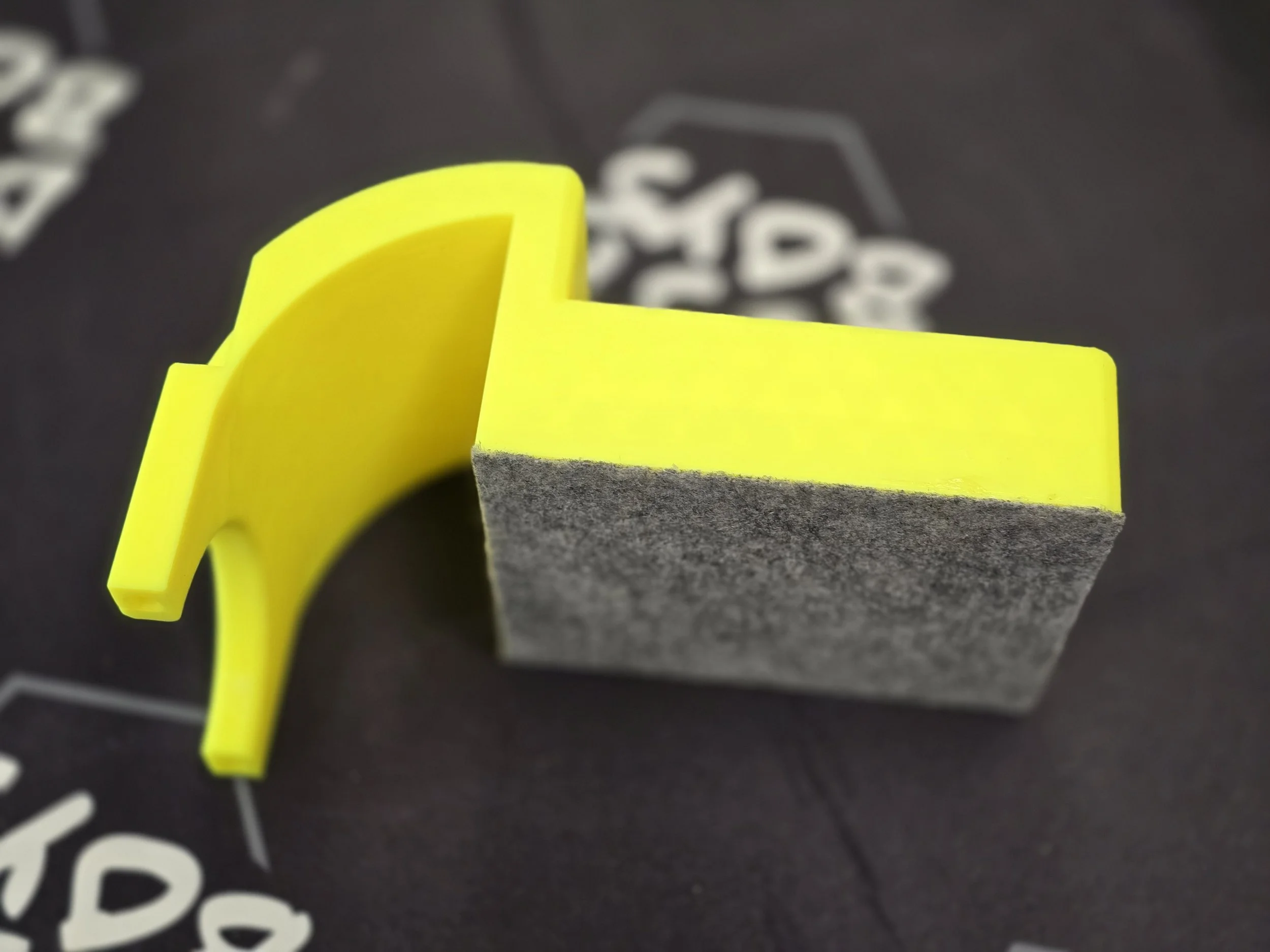 Close-up of the edge guide's felt underside and curved mounting arm